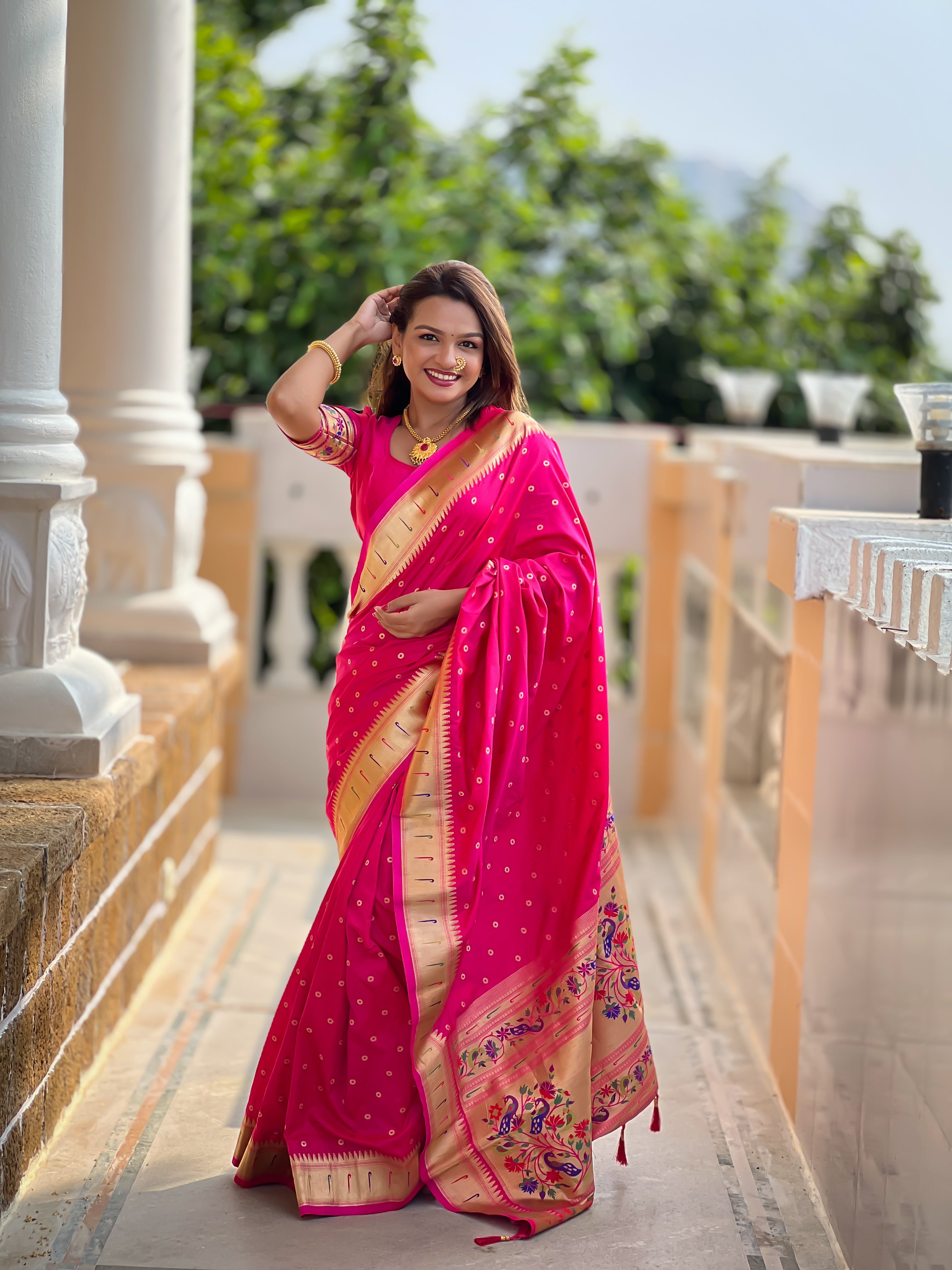 Model wearing Rani Pink Soft Paithani Silk Saree with gold zari Meenakari border and rich pallu for wedding