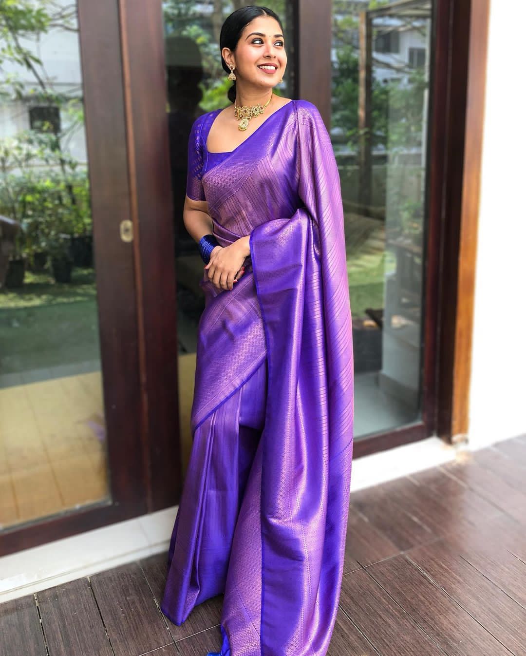 Banarasi Silk saree collection featuring heavy traditional zari weaving and high luster; available in four classic auspicious colors, including red, green, blue, and gold.