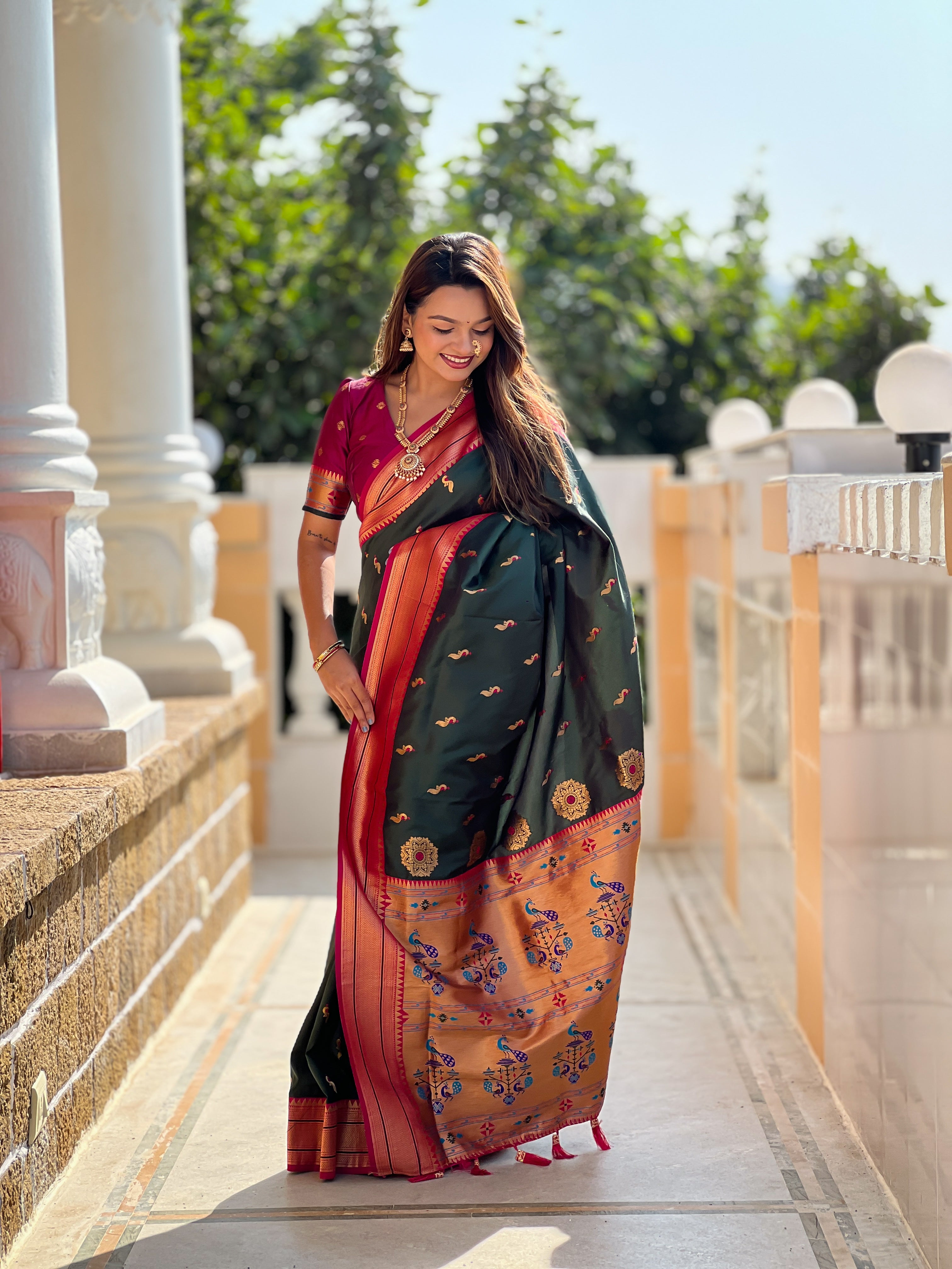 Woman wearing soft Paithani silk saree with meenakari zari border and rich pallu