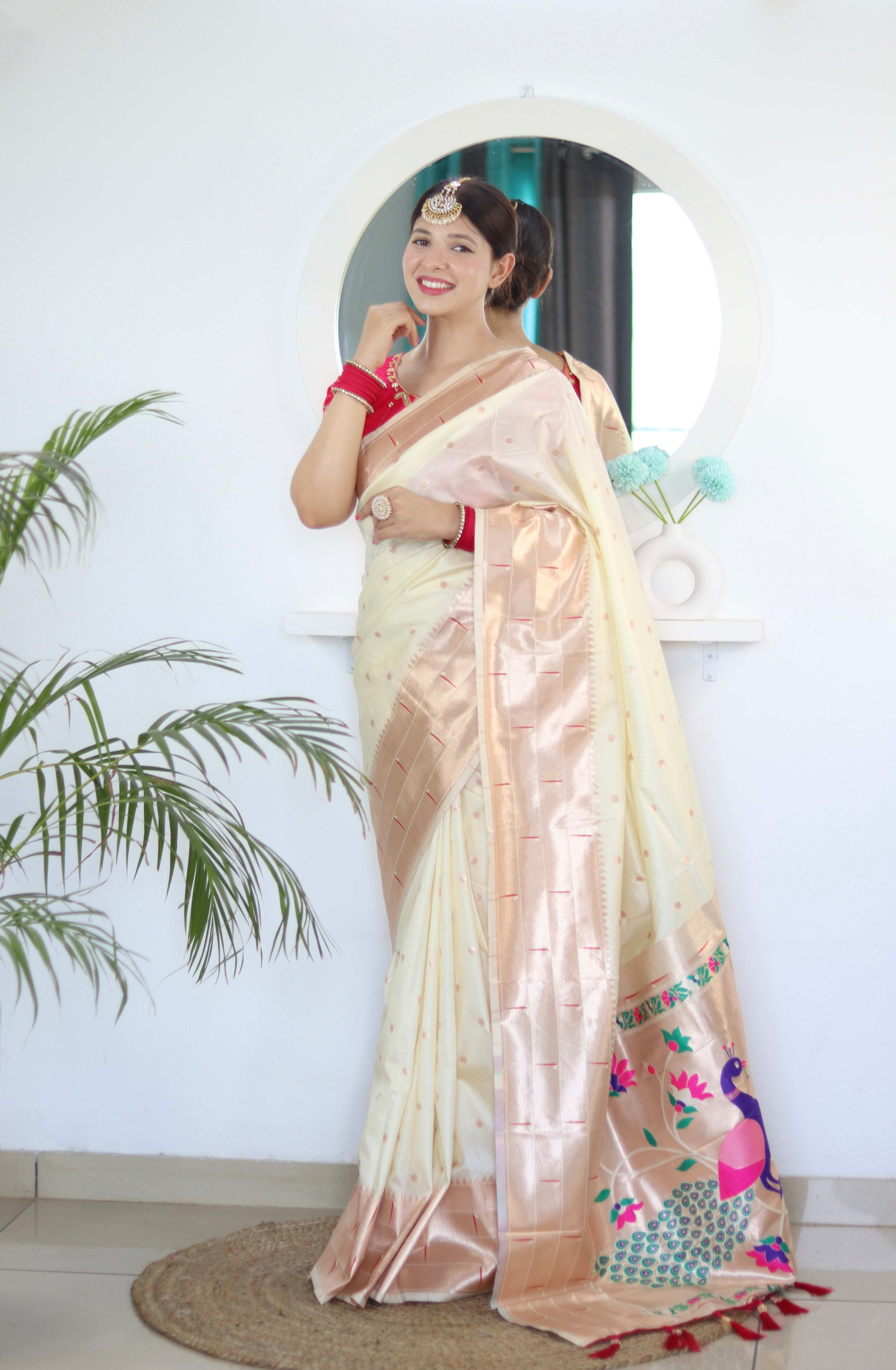 Model wearing Cream Soft Kanjivaram Paithani Silk Saree with Meenakari Zari weaving and rich swan border