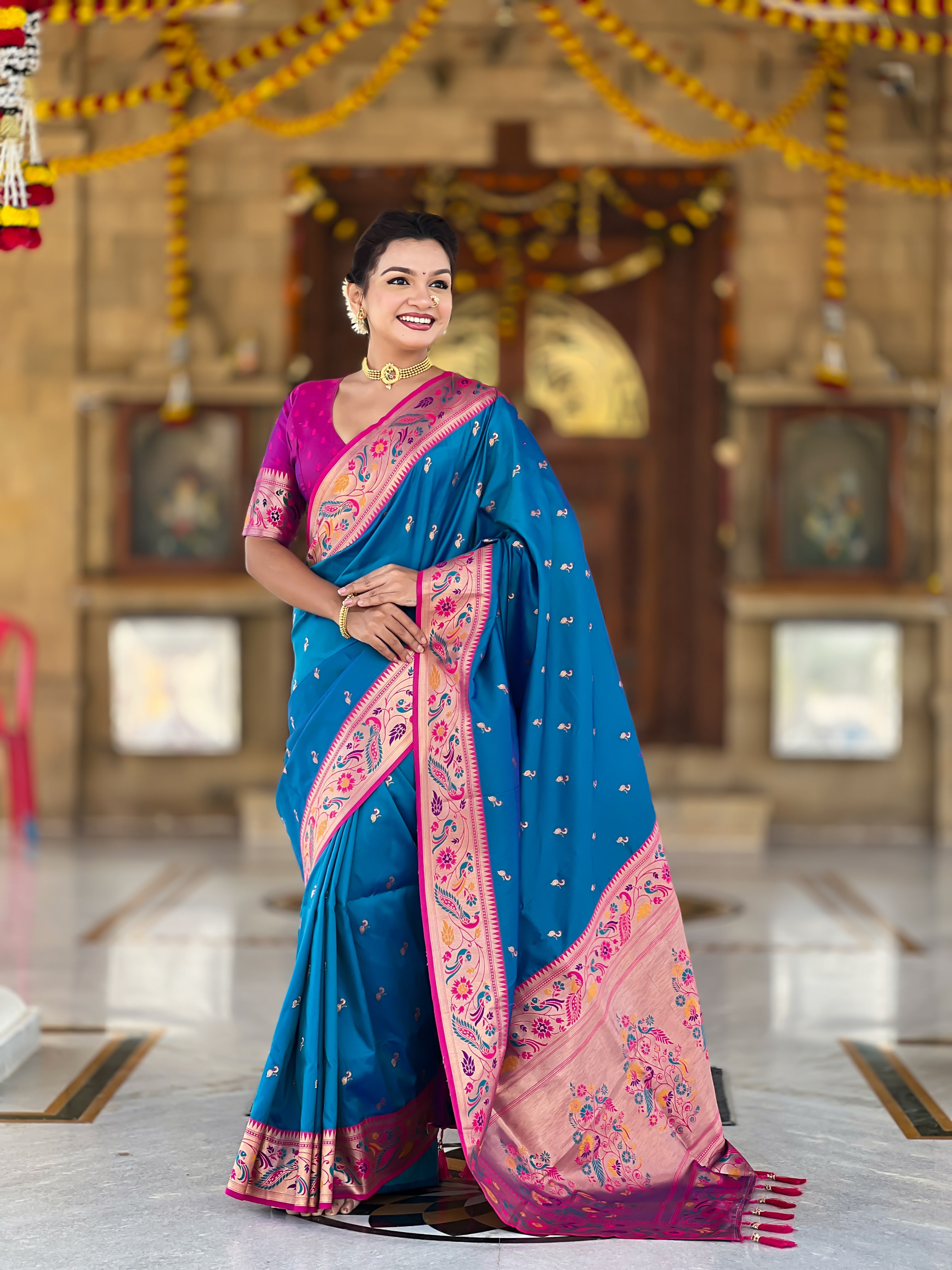 Woman wearing Mehendi Soft Paithani Silk Saree with pink border and Meenakari Zari weaving motifs