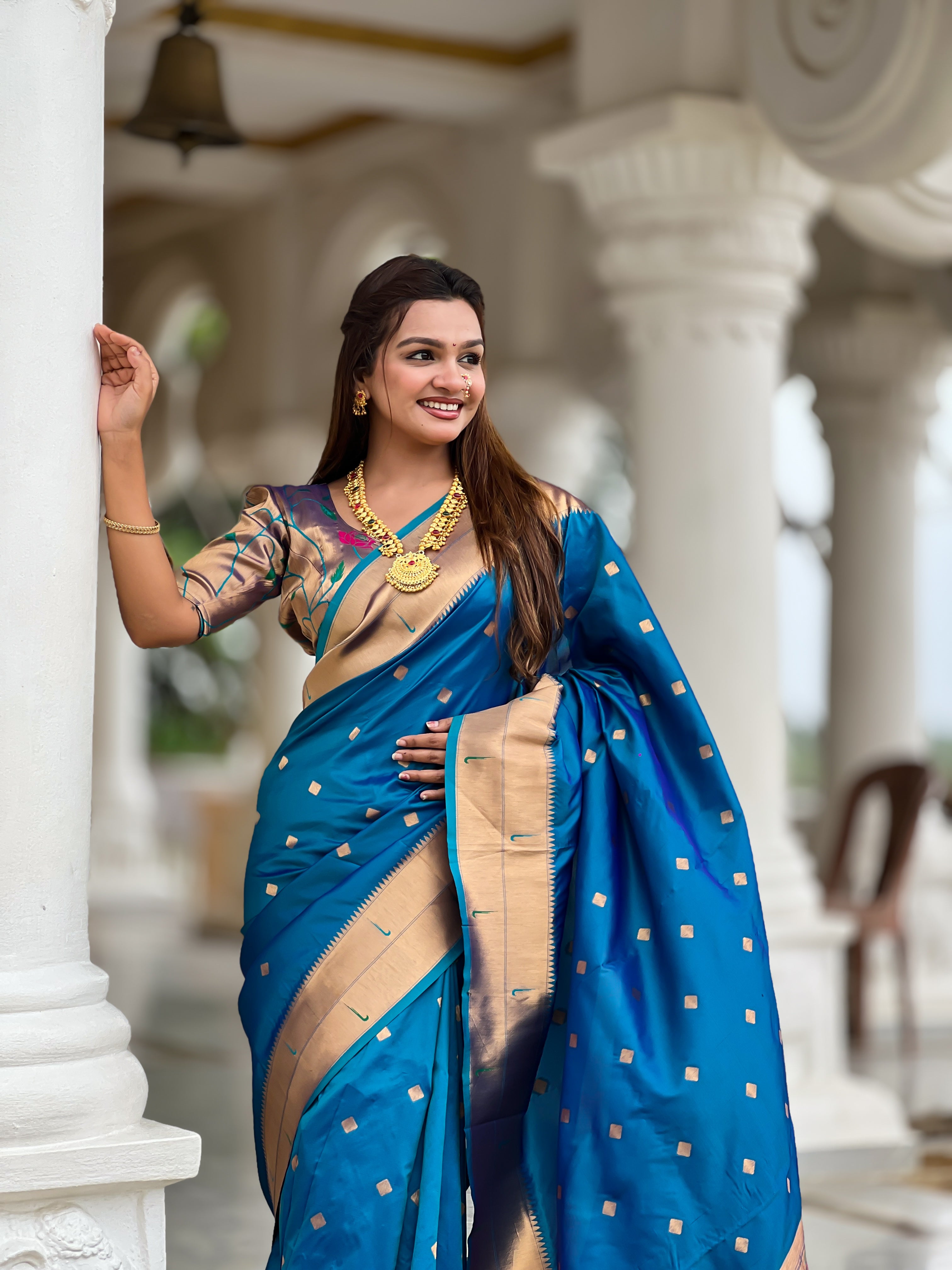 Woman wearing majestic Soft Paithani Silk Saree with Meenakari weaving and double munia border
