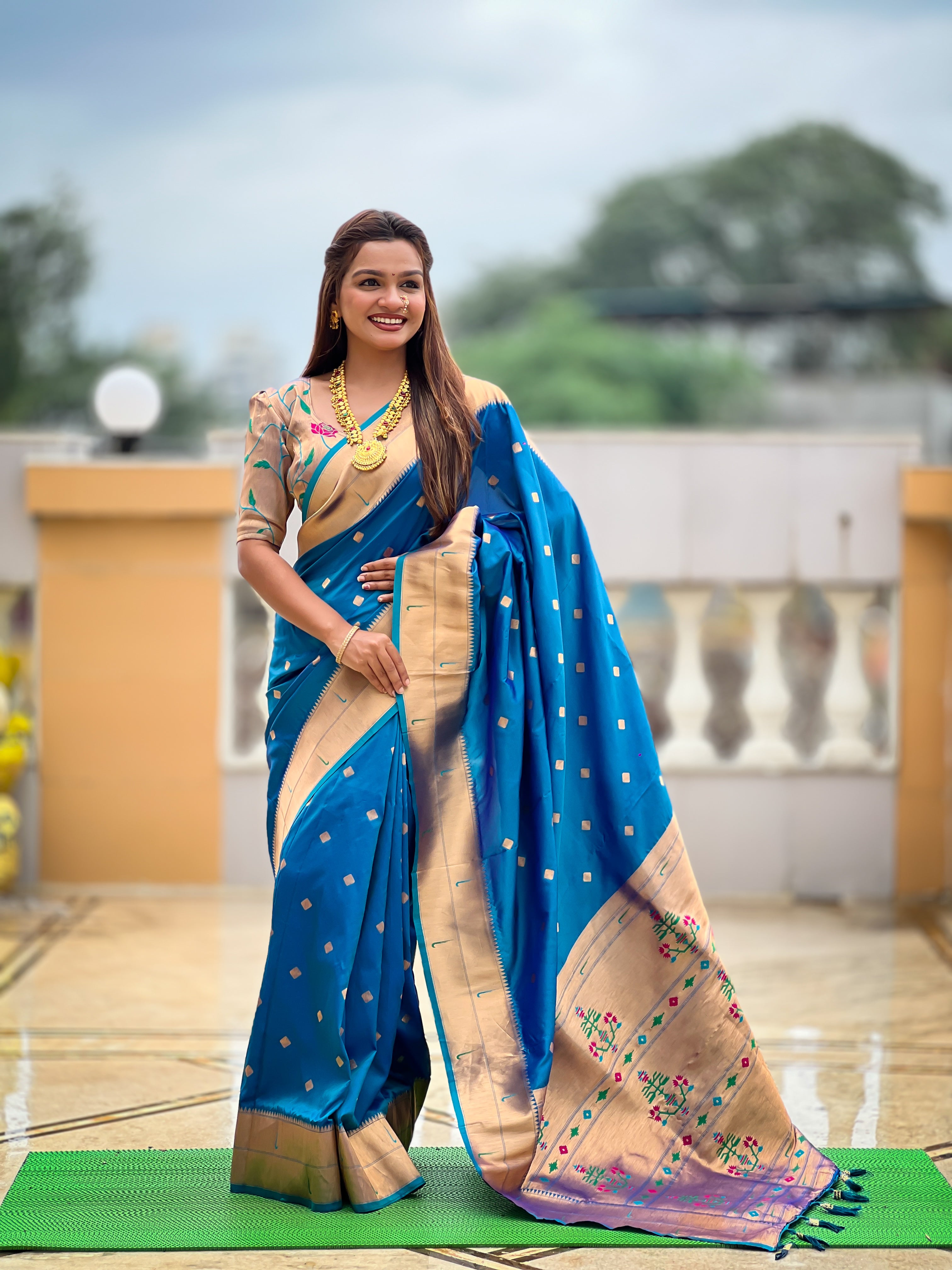 Woman wearing majestic Soft Paithani Silk Saree with Meenakari weaving and double munia border