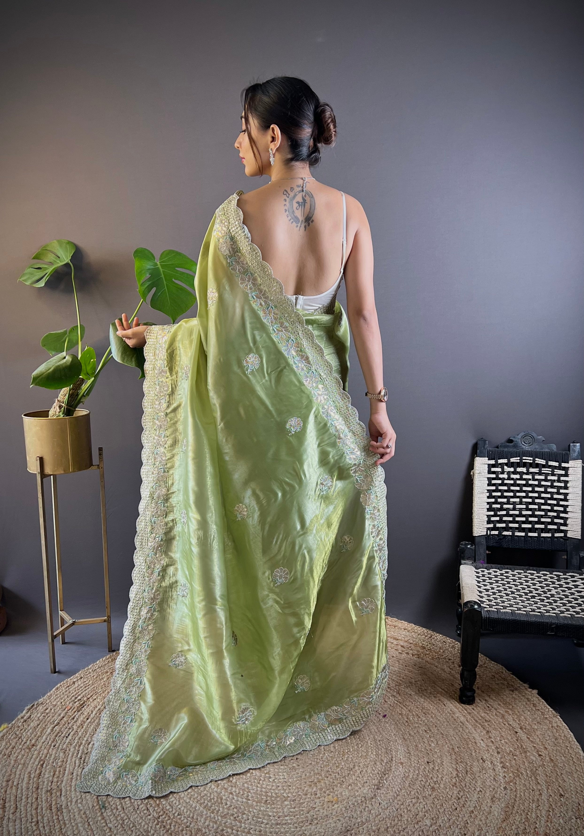 Model wearing shimmering teal blue Gold Crunchy saree with floral sequence embroidery and cutwork border
