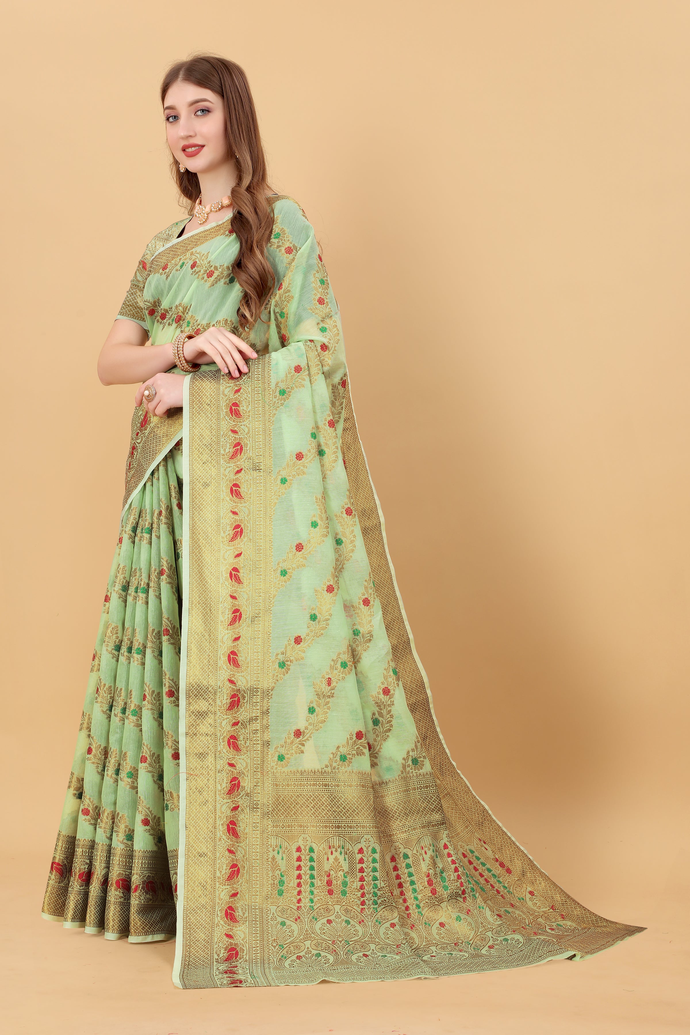 Model wearing Pista Green Soft Cotton Saree with intricate gold Zari weaving and rich pallu design