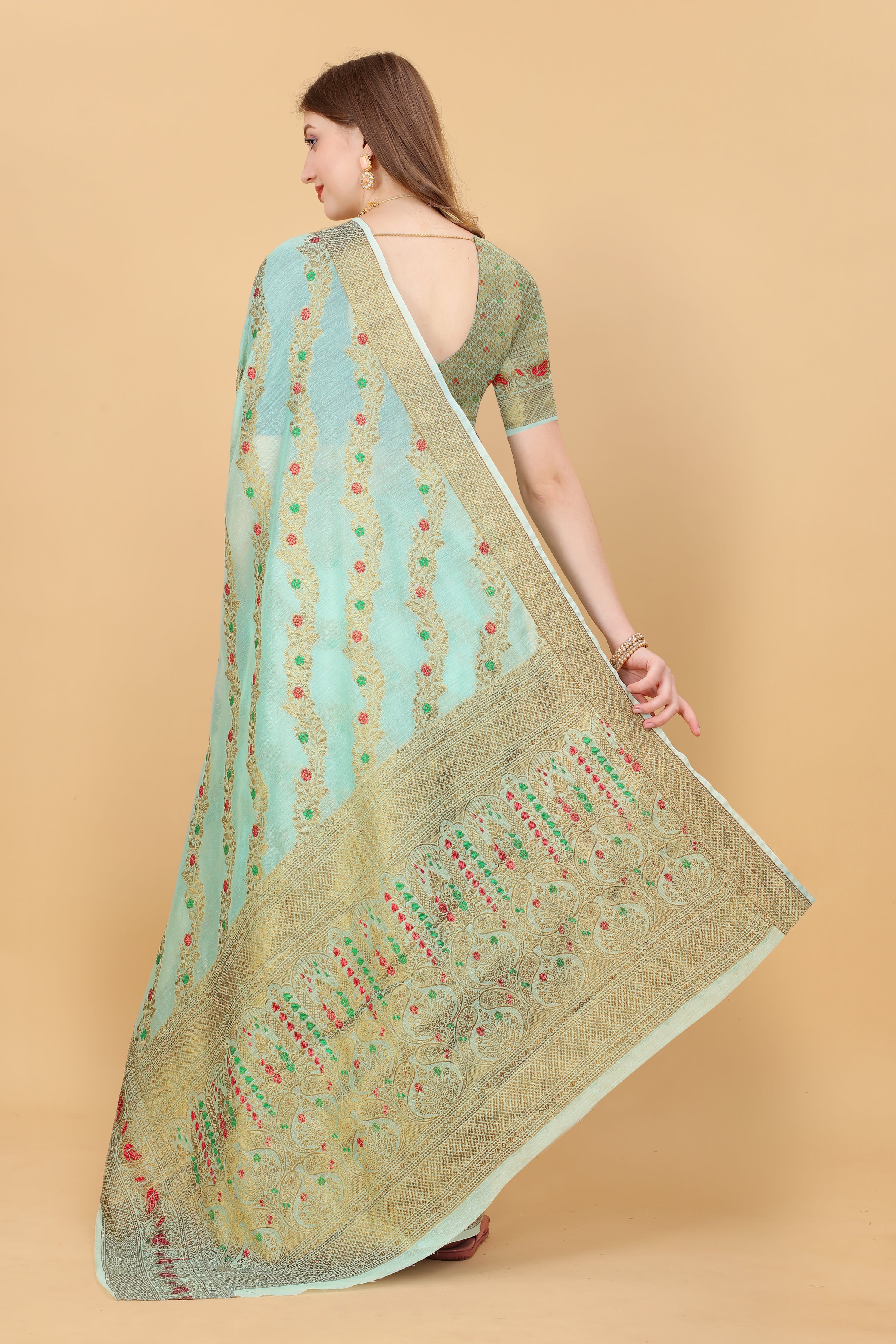 Model wearing Firozi Soft Cotton Saree with intricate gold Zari weaving and rich pallu design