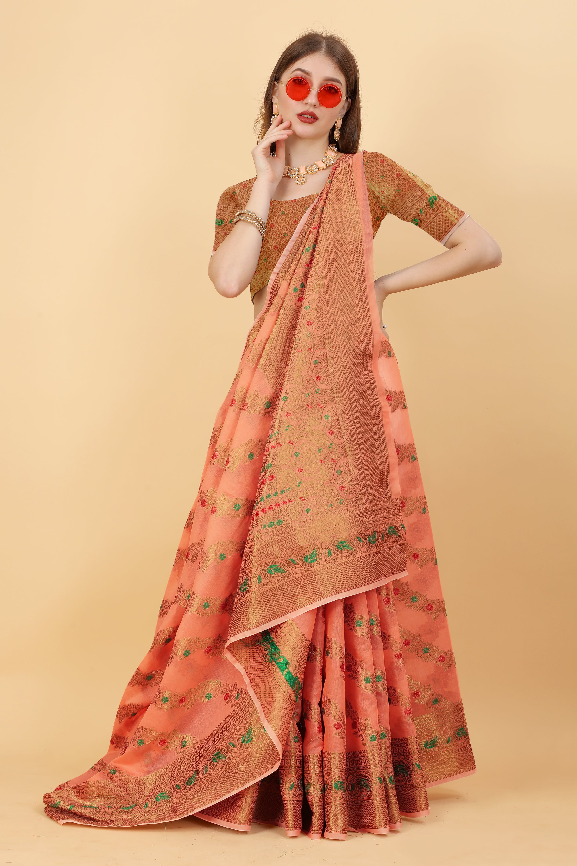 Model wearing Soft Peach Soft Cotton Saree with intricate gold Zari weaving and rich pallu design