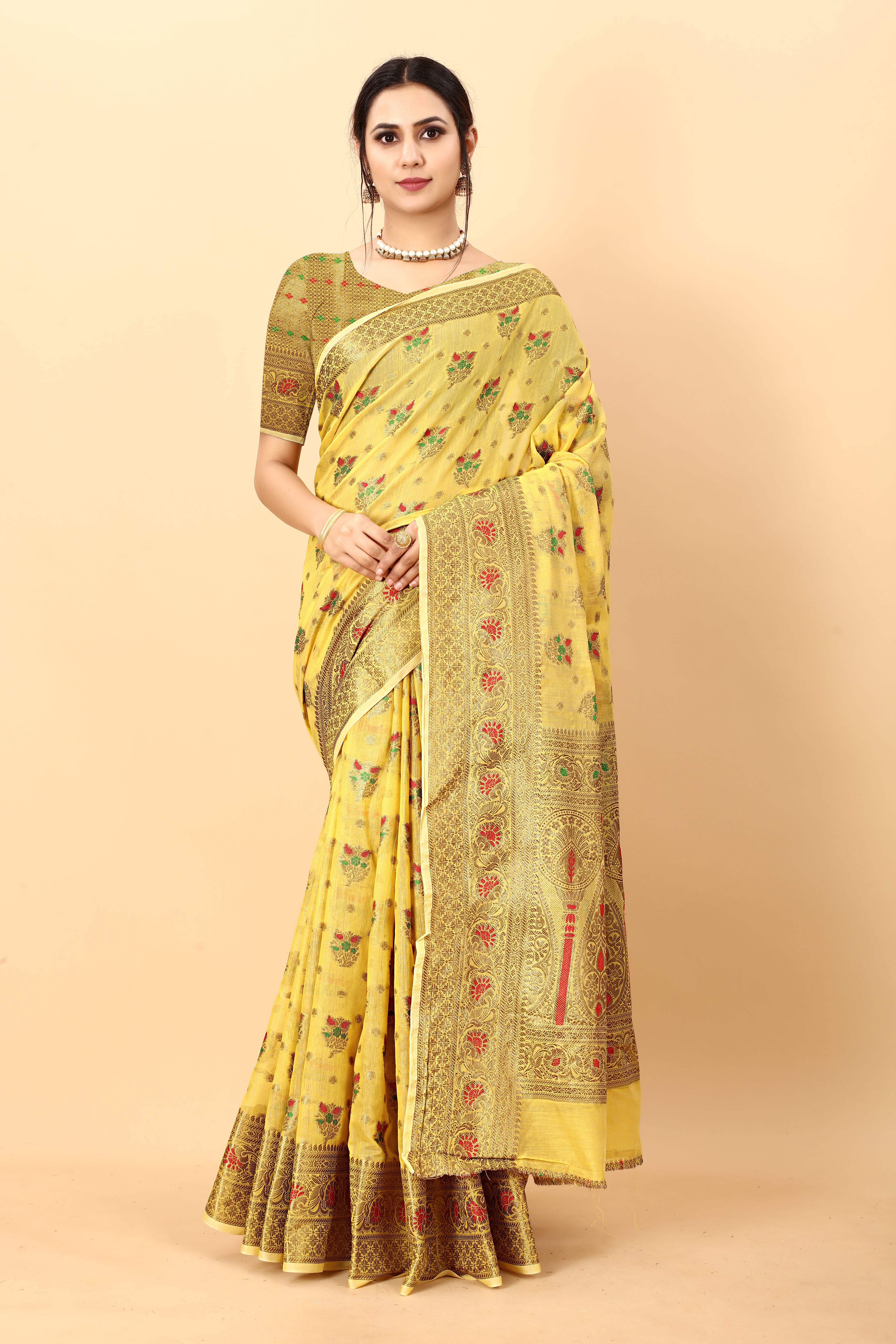 Model wearing yellow soft cotton silk saree with rich golden zari woven pallu and floral motifs