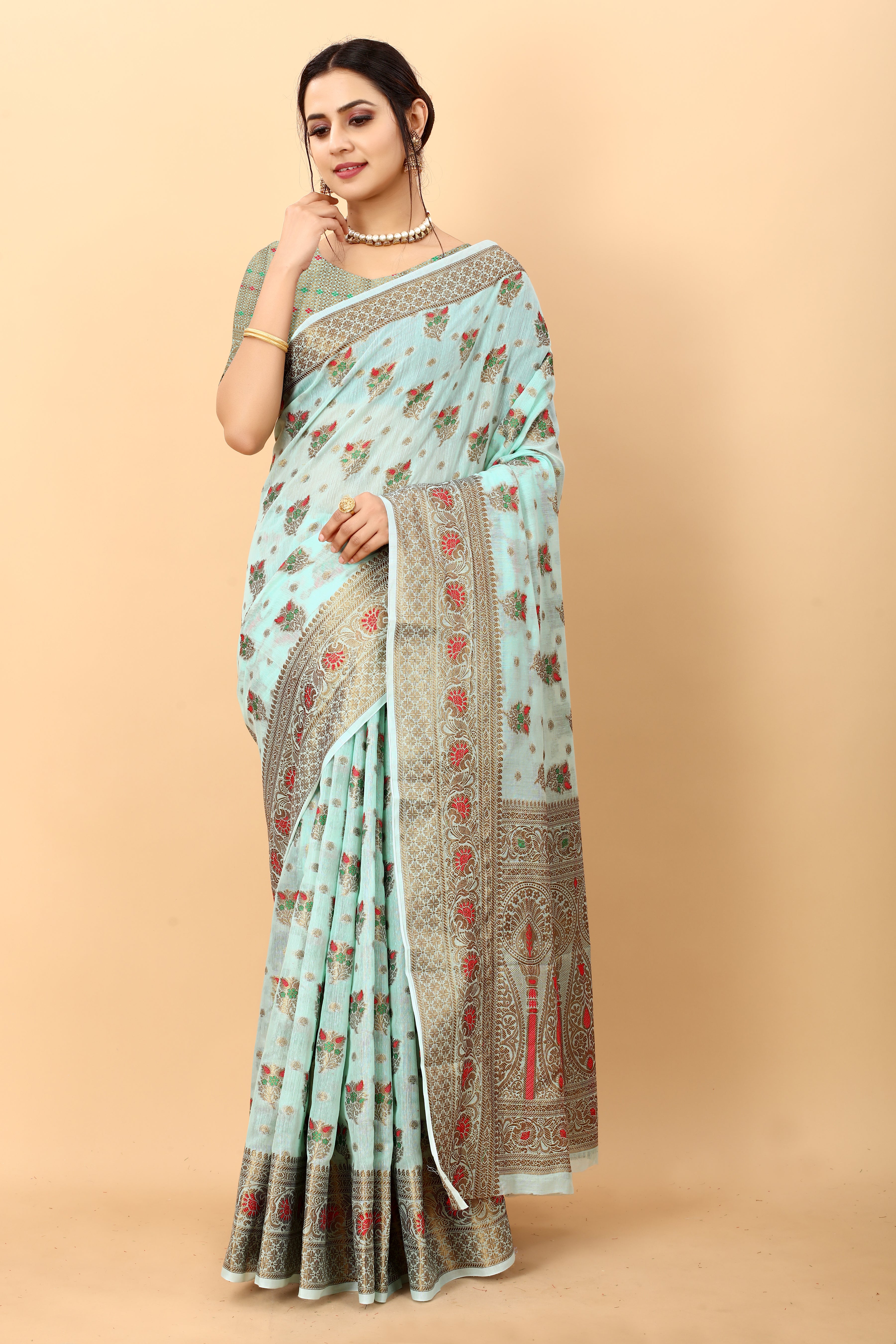 Model wearing Firozi soft cotton silk saree with rich golden zari woven pallu and floral motifs