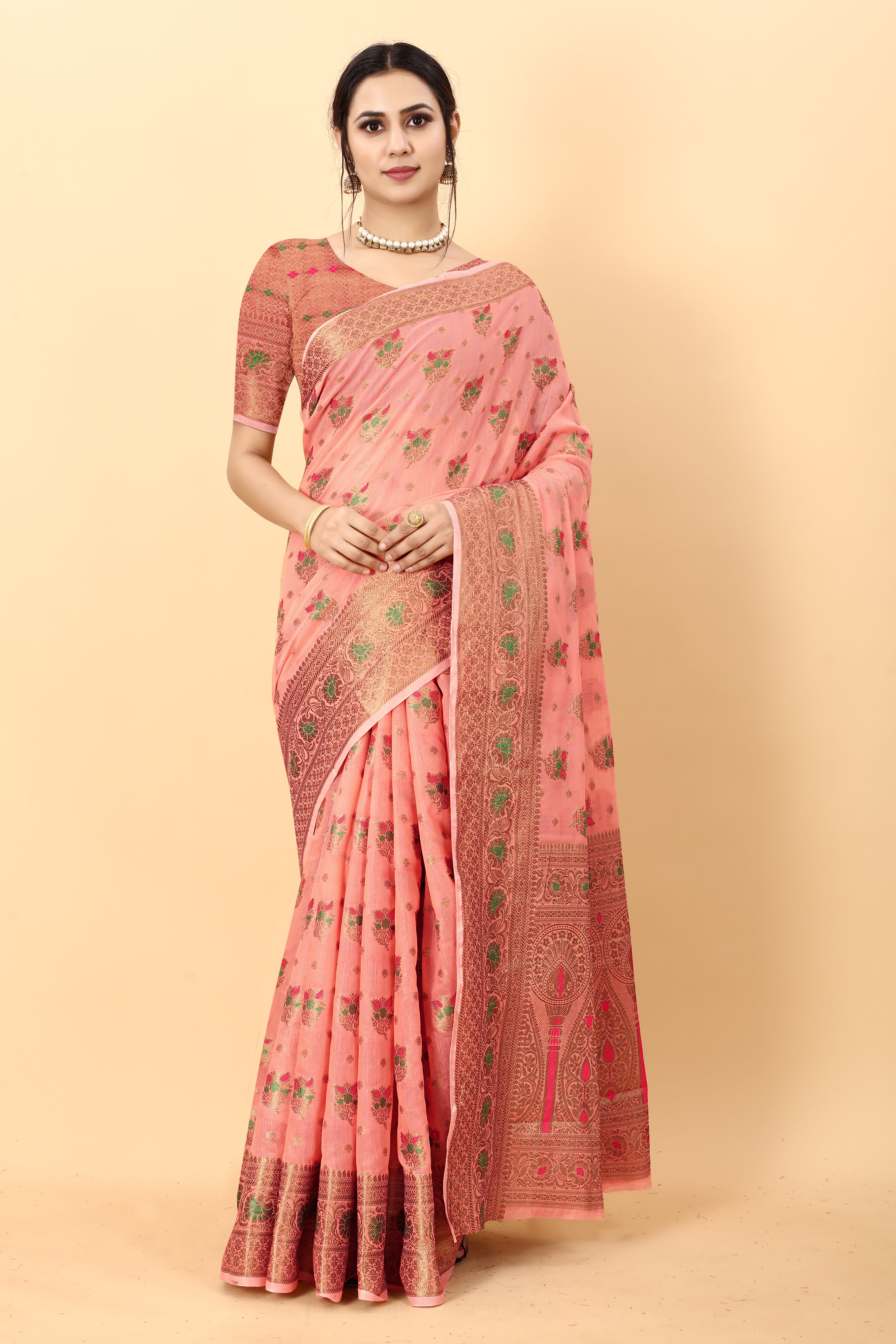 Model wearing Pink soft cotton silk saree with rich golden zari woven pallu and floral motifs