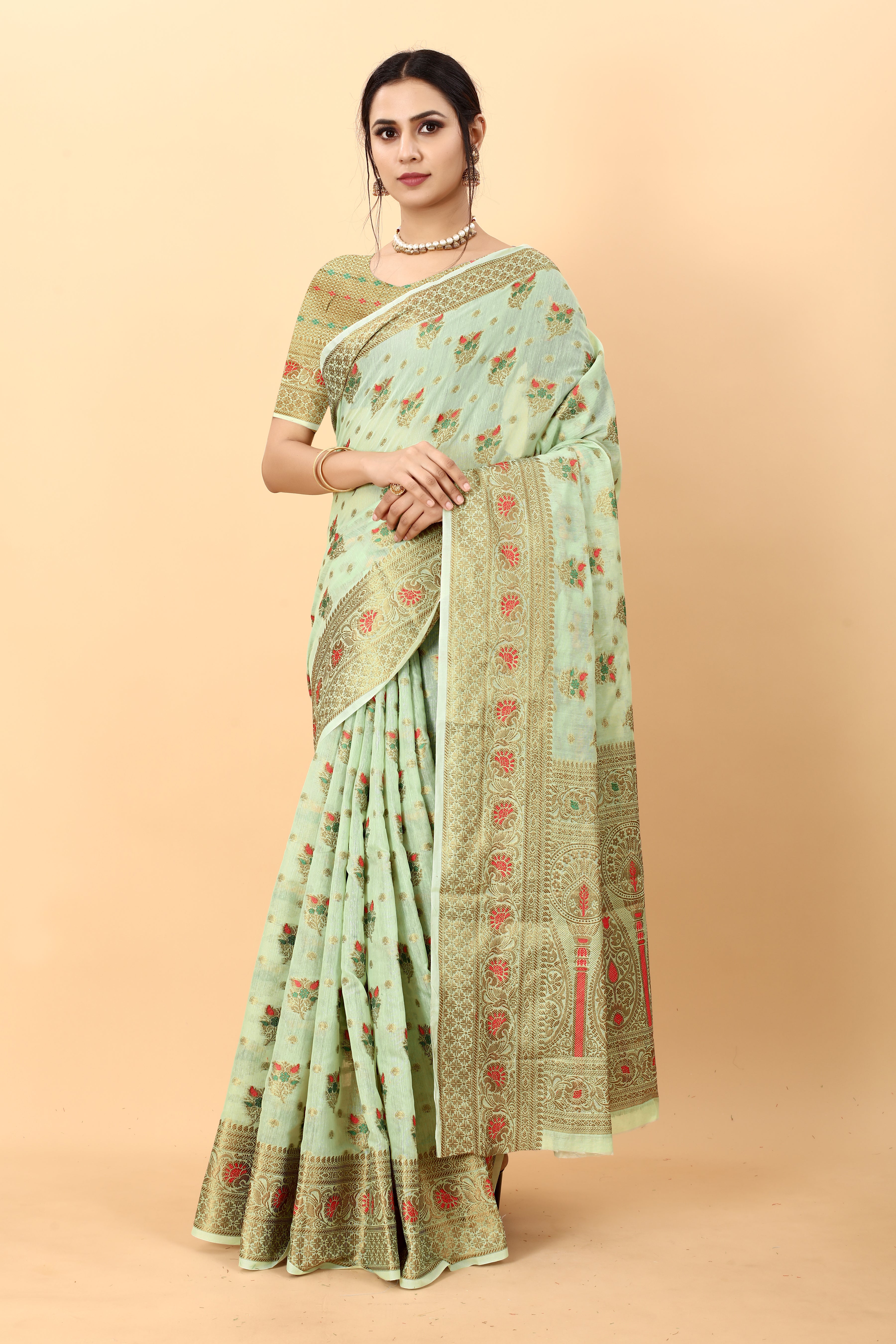 Model wearing Pista soft cotton silk saree with rich golden zari woven pallu and floral motifs