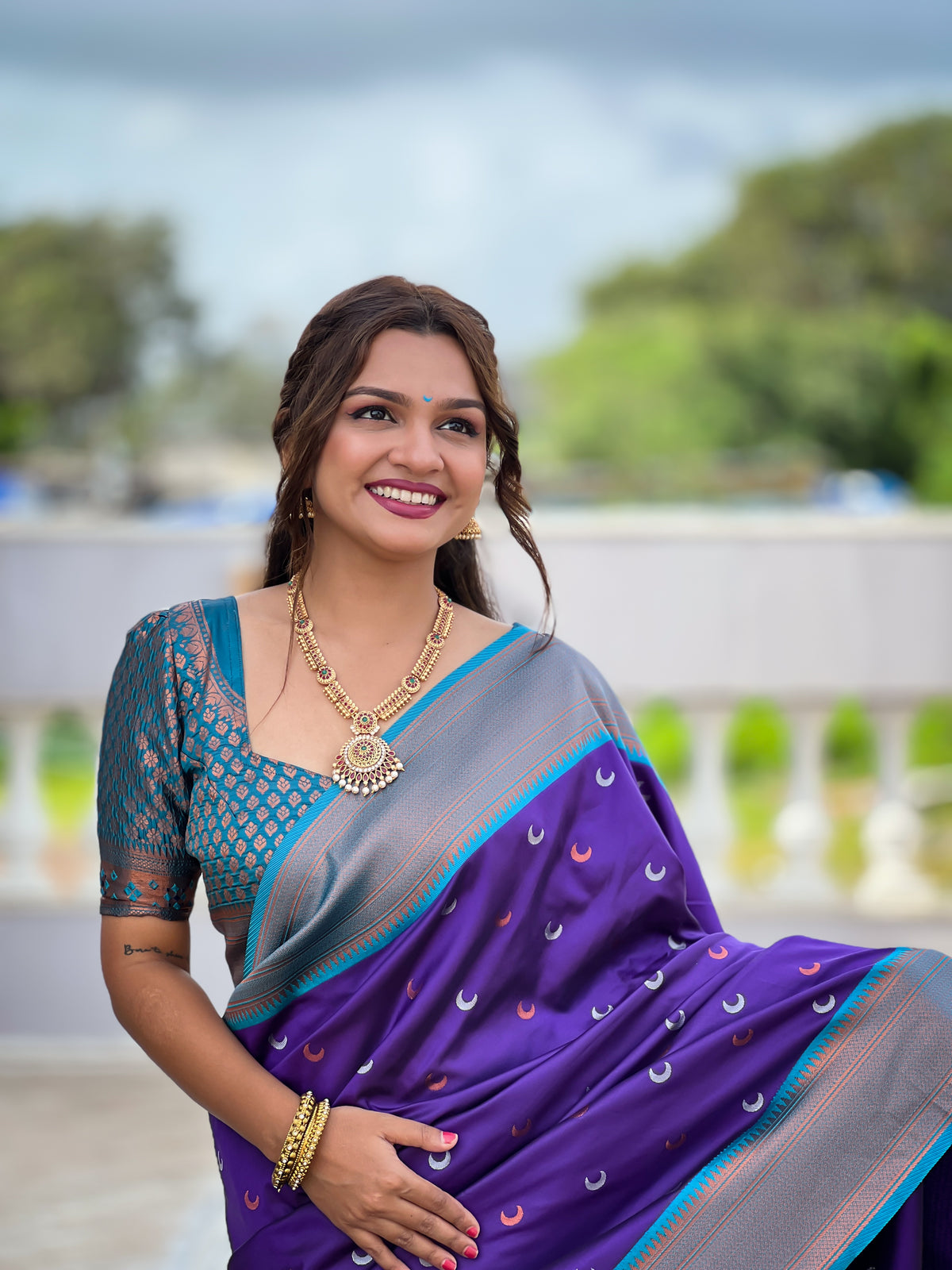 Soft Paithani Silk Saree; Pure Paithani Zari Weaving; Traditional Meenakari Moon Design Saree; Rich Meenakari Woven Pallu and Border; Tassels on Pallu; Contrast Woven Silk Blouse with Sleeve Border