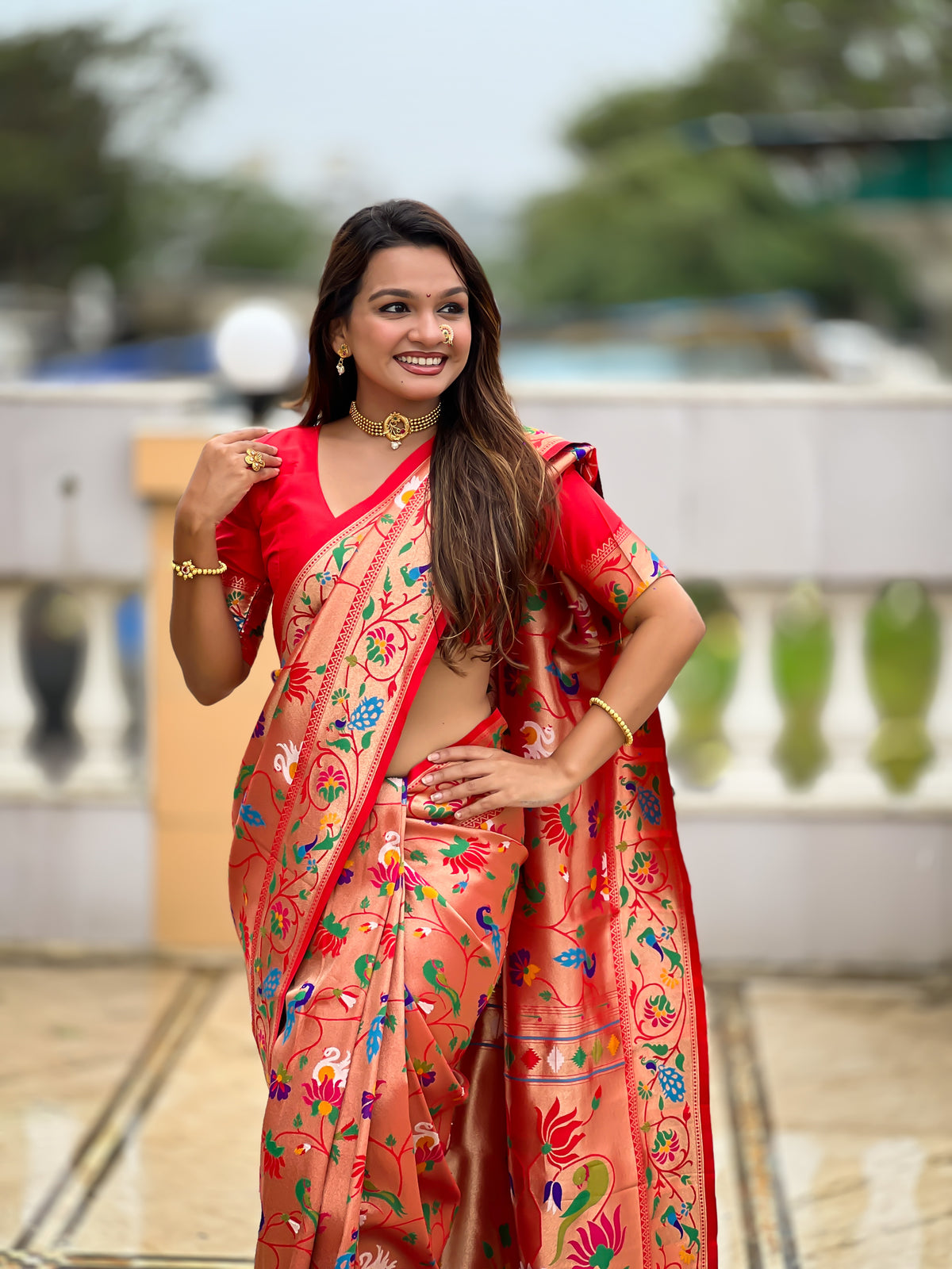 Woman wearing a peach Soft Kanjivaram Paithani Silk Saree with colorful Meenakari floral weaving and zari swan border