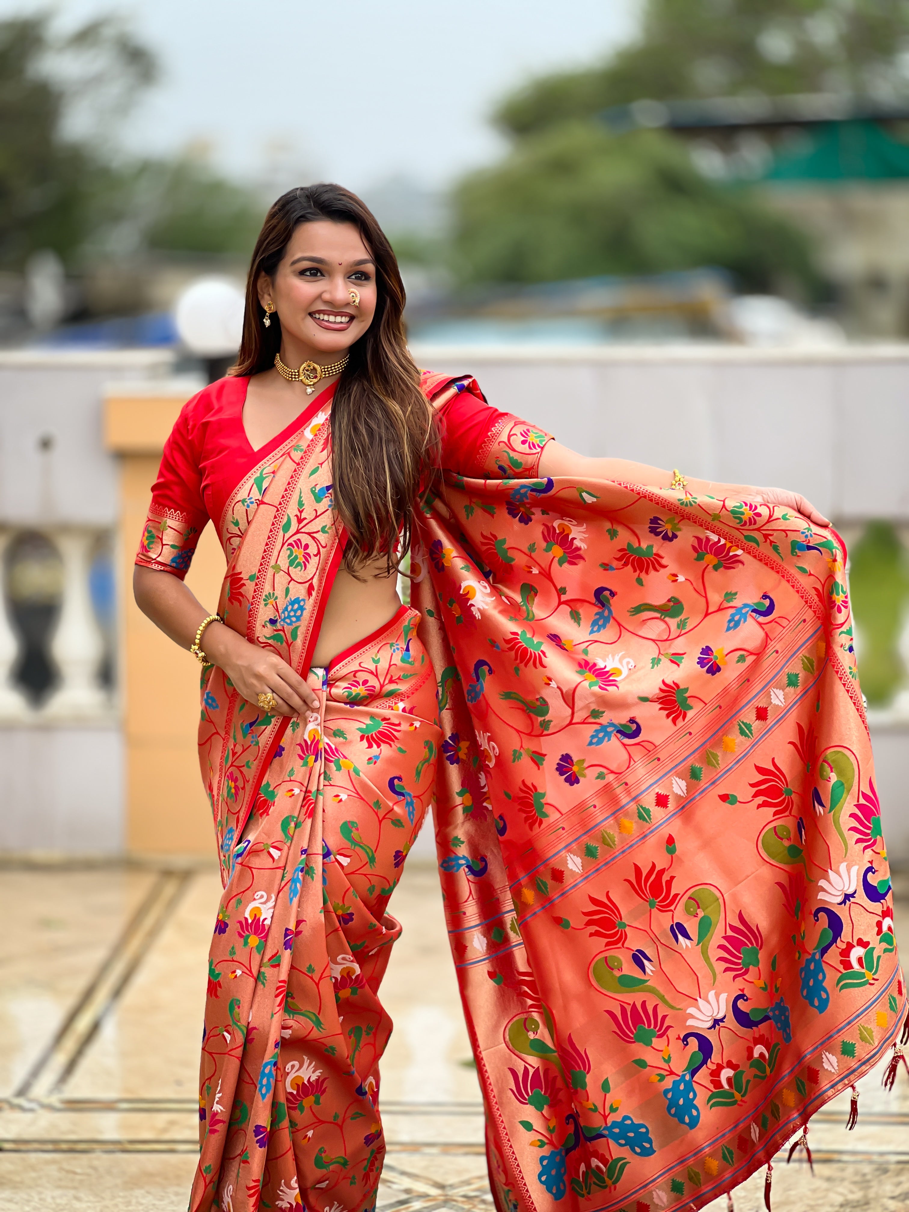 Woman wearing a peach Soft Kanjivaram Paithani Silk Saree with colorful Meenakari floral weaving and zari swan border