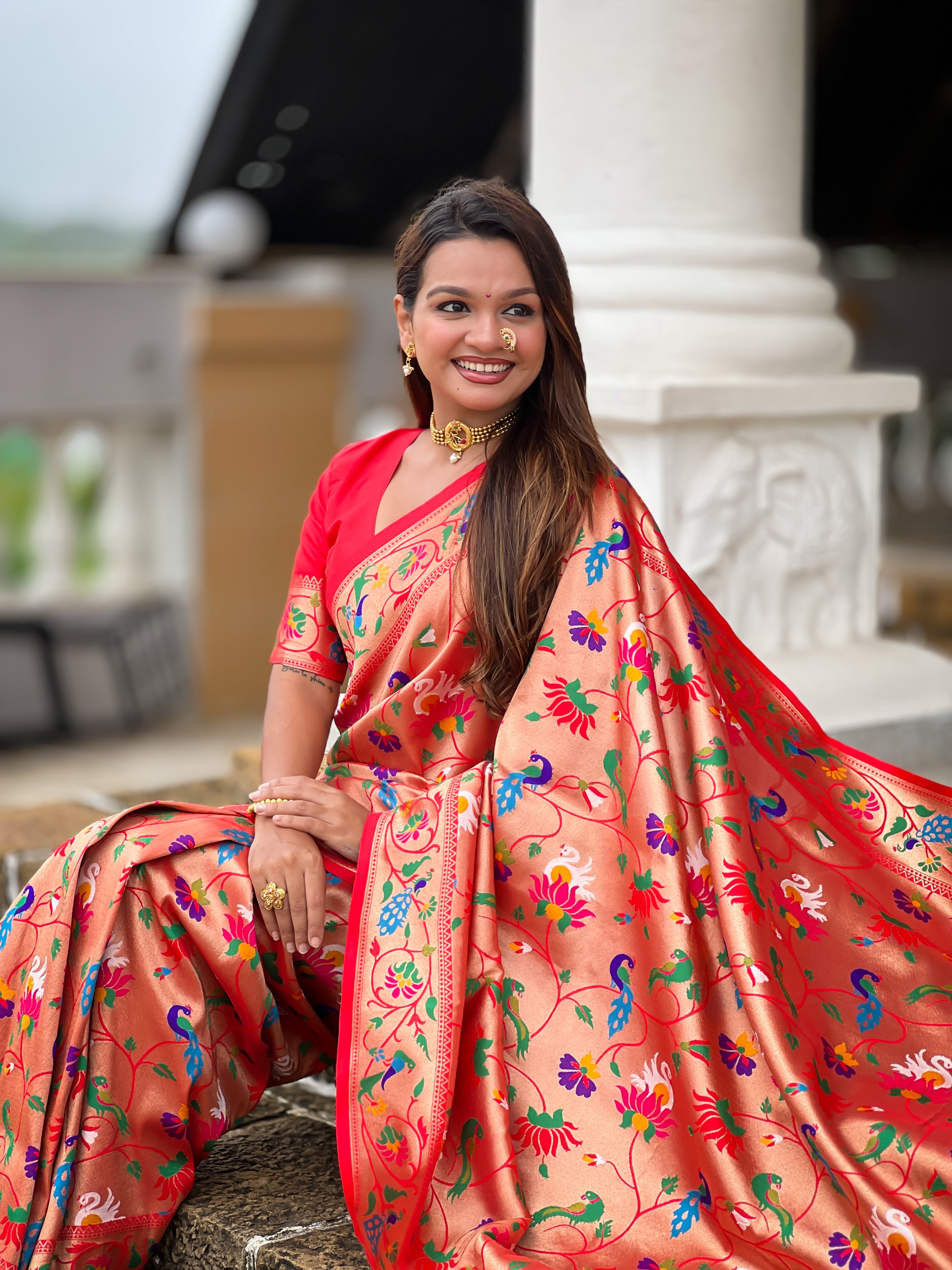 Woman wearing a peach Soft Kanjivaram Paithani Silk Saree with colorful Meenakari floral weaving and zari swan border