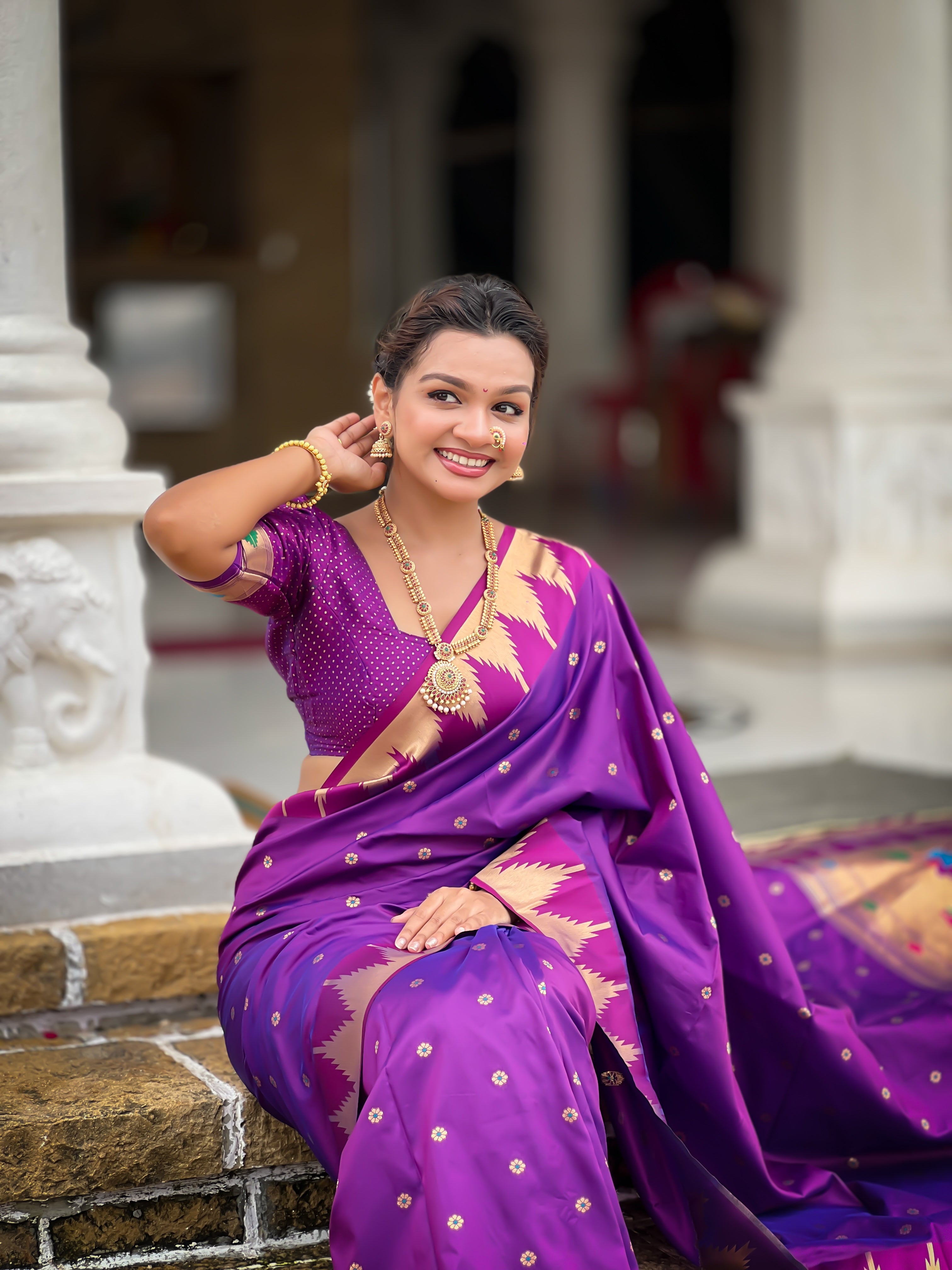 Firozi blue soft Paithani silk saree with Meenakari pallu and temple border worn by a model in a traditional setting