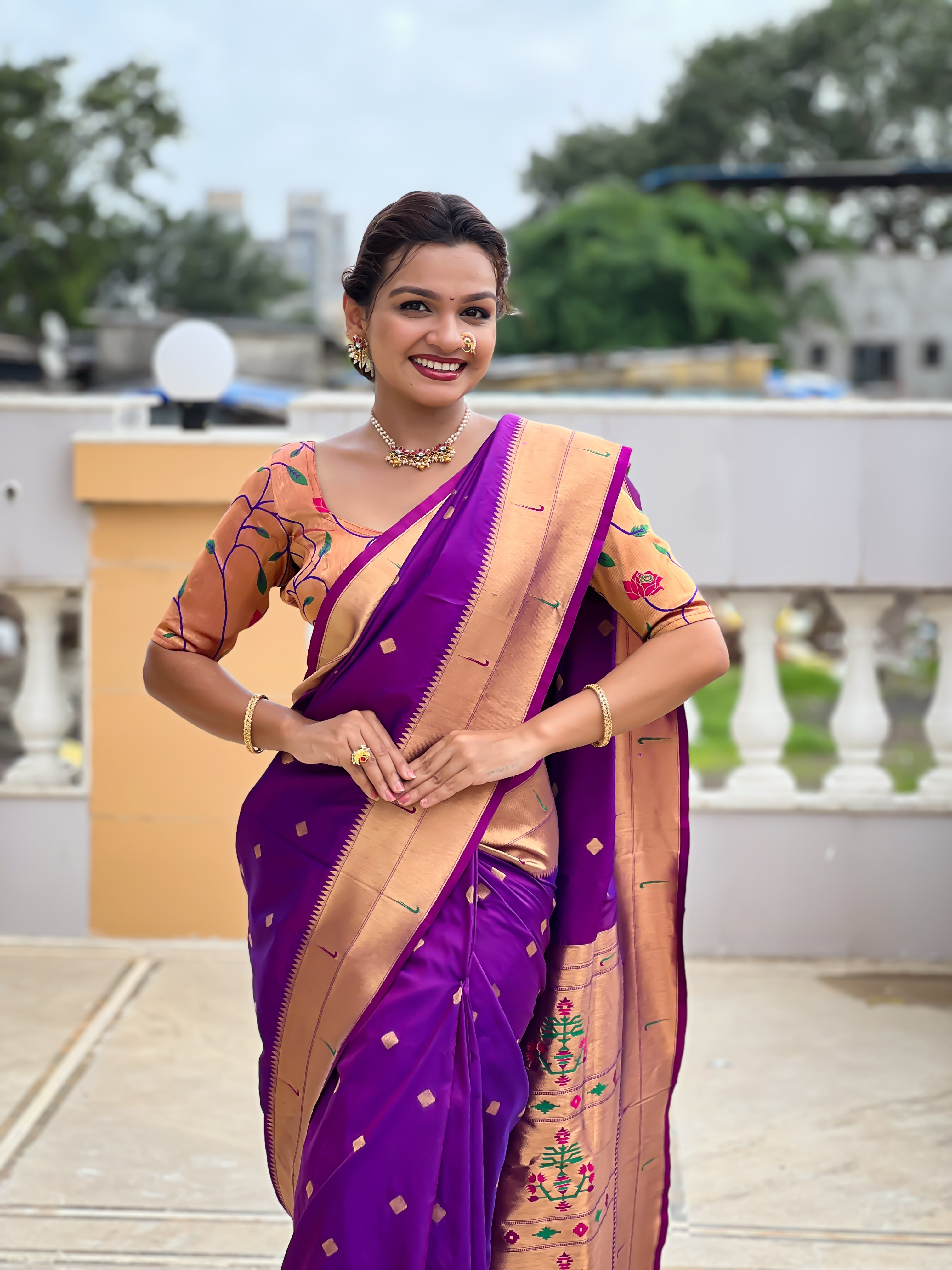 Woman wearing majestic Soft Paithani Silk Saree with Meenakari weaving and double munia border