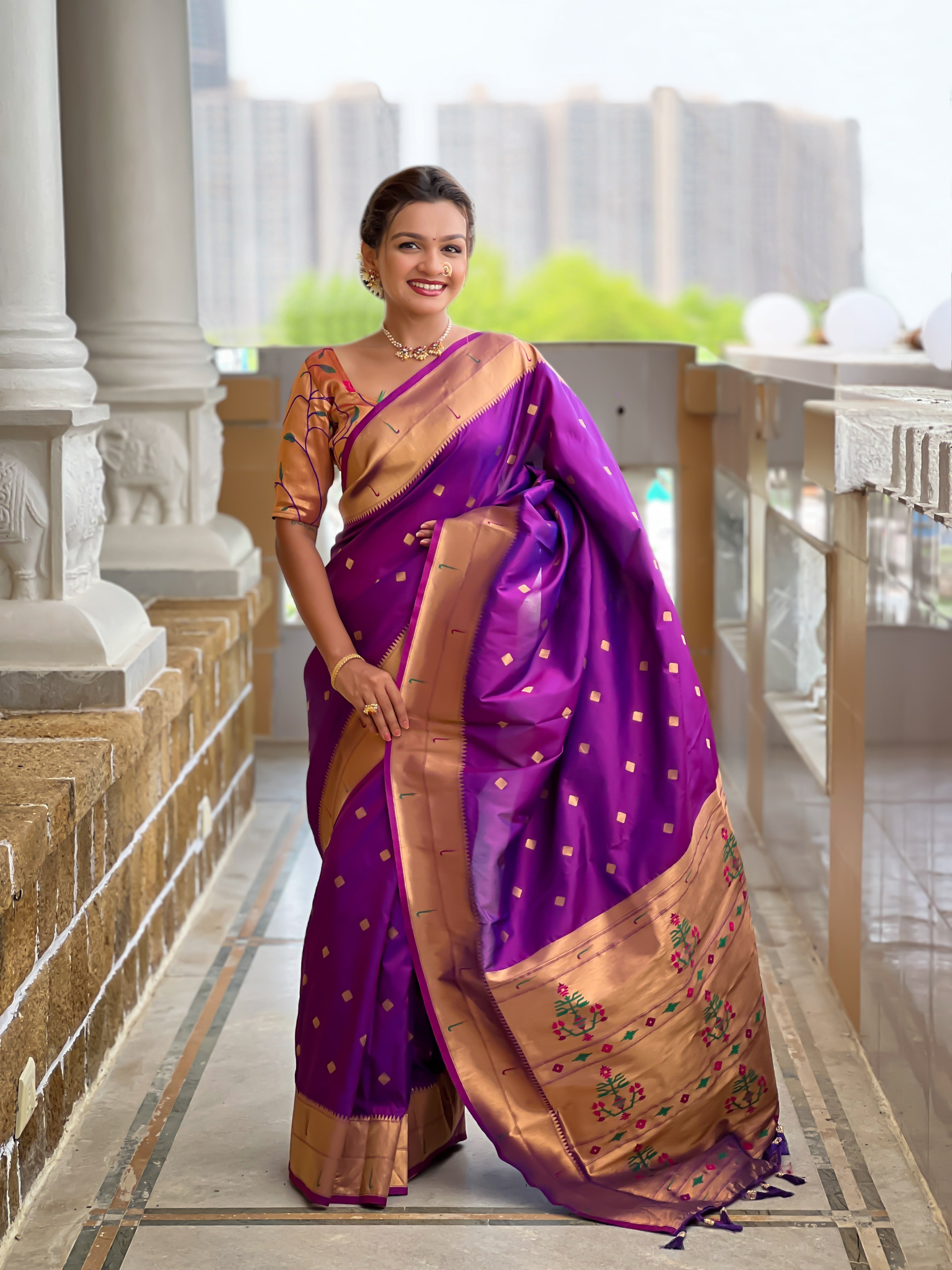 Woman wearing majestic Soft Paithani Silk Saree with Meenakari weaving and double munia border