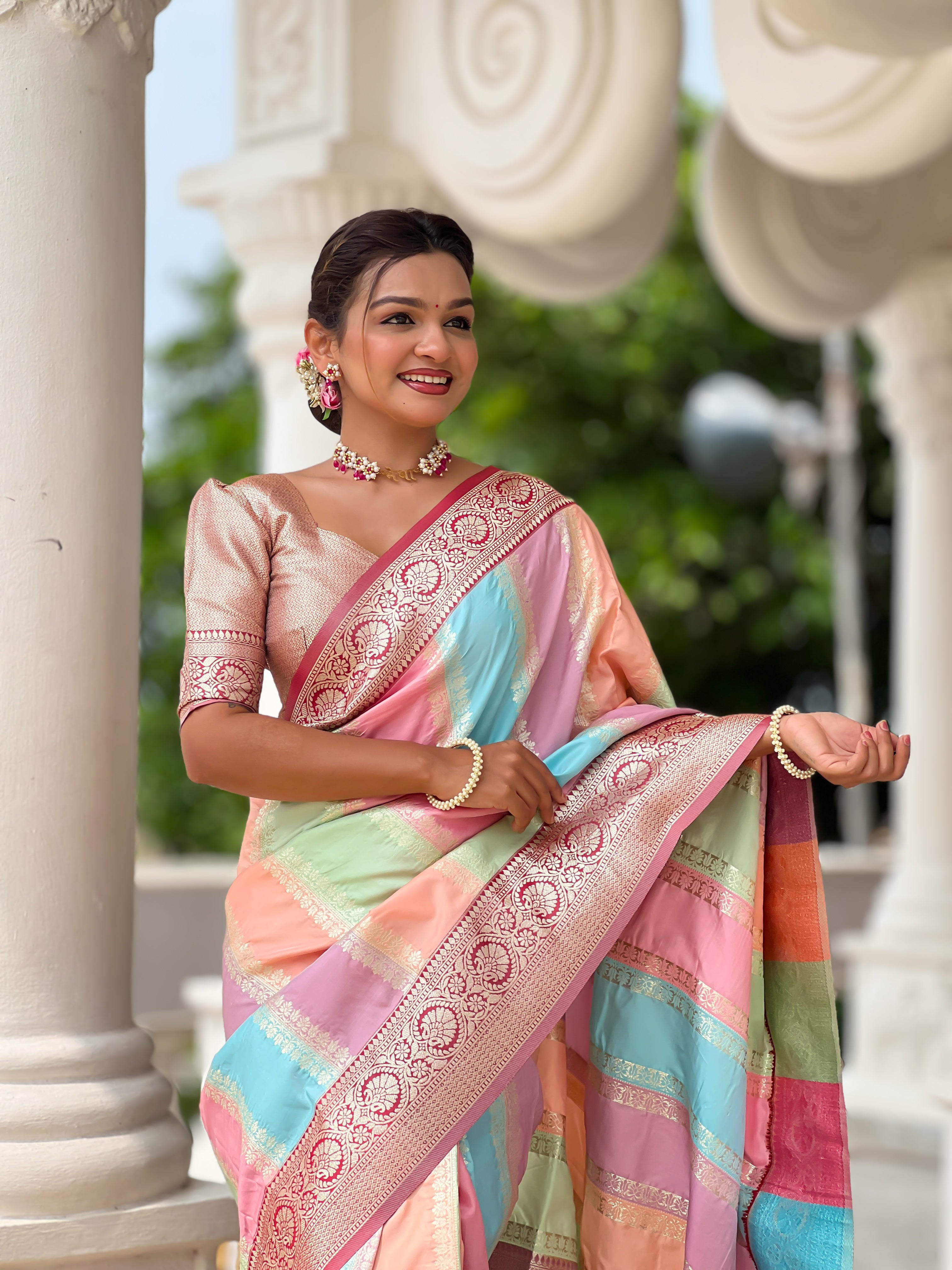 Woman wearing multi-colored pastel soft silk saree with intricate Maroon zari border and Meenakari weaving details