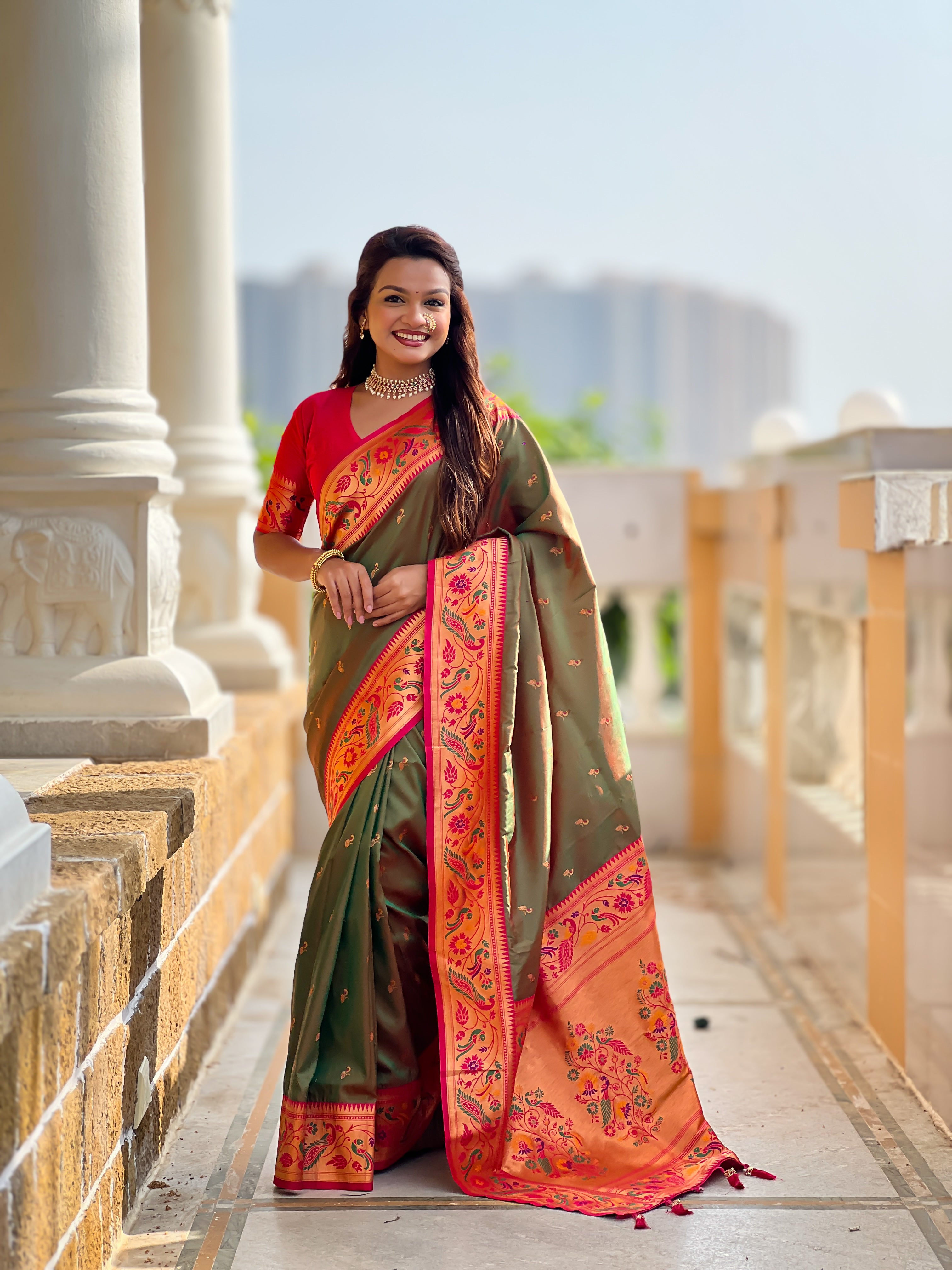 Woman wearing Mehendi Soft Paithani Silk Saree with pink border and Meenakari Zari weaving motifs