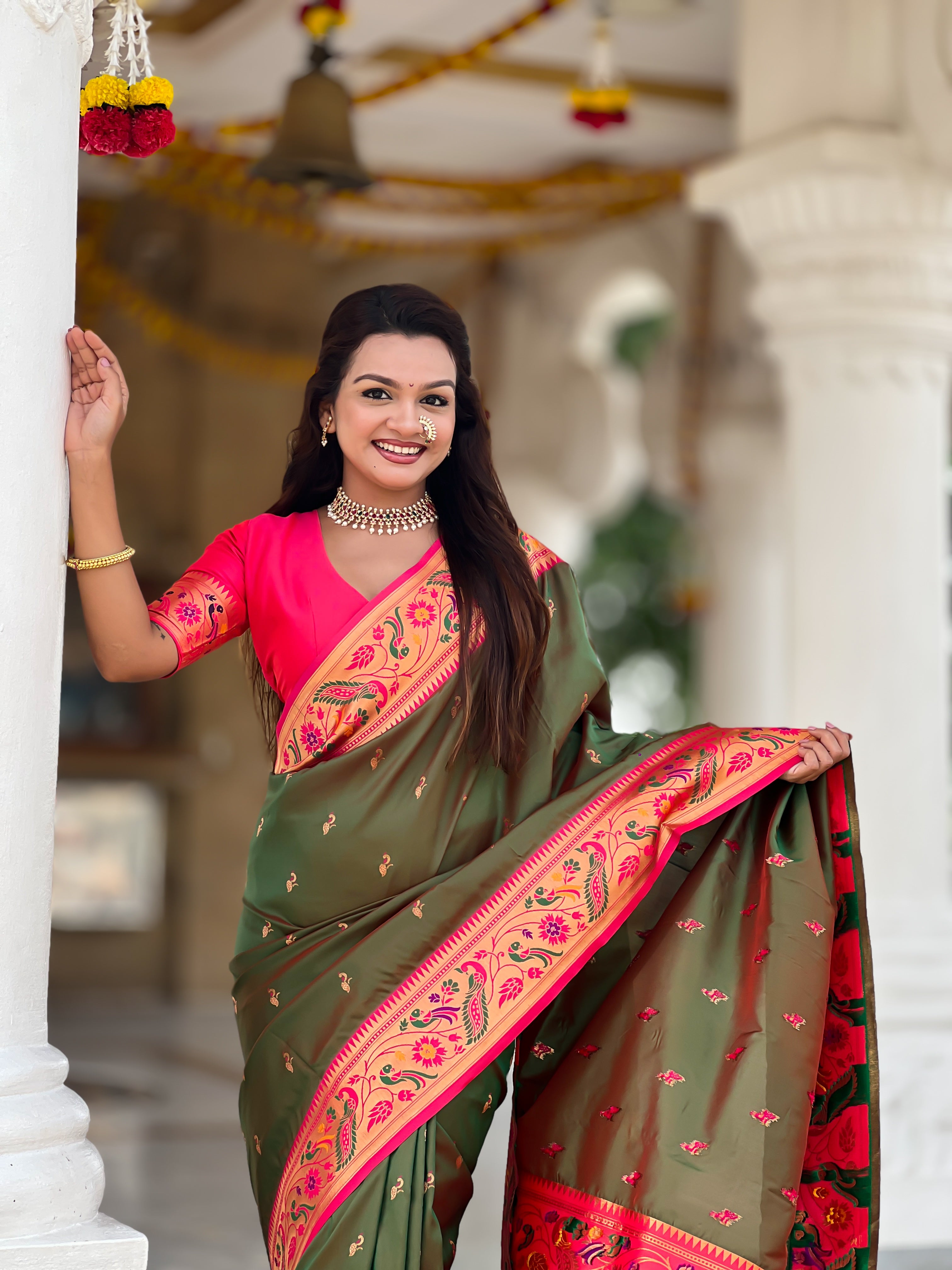 Woman wearing Mehendi Soft Paithani Silk Saree with pink border and Meenakari Zari weaving motifs