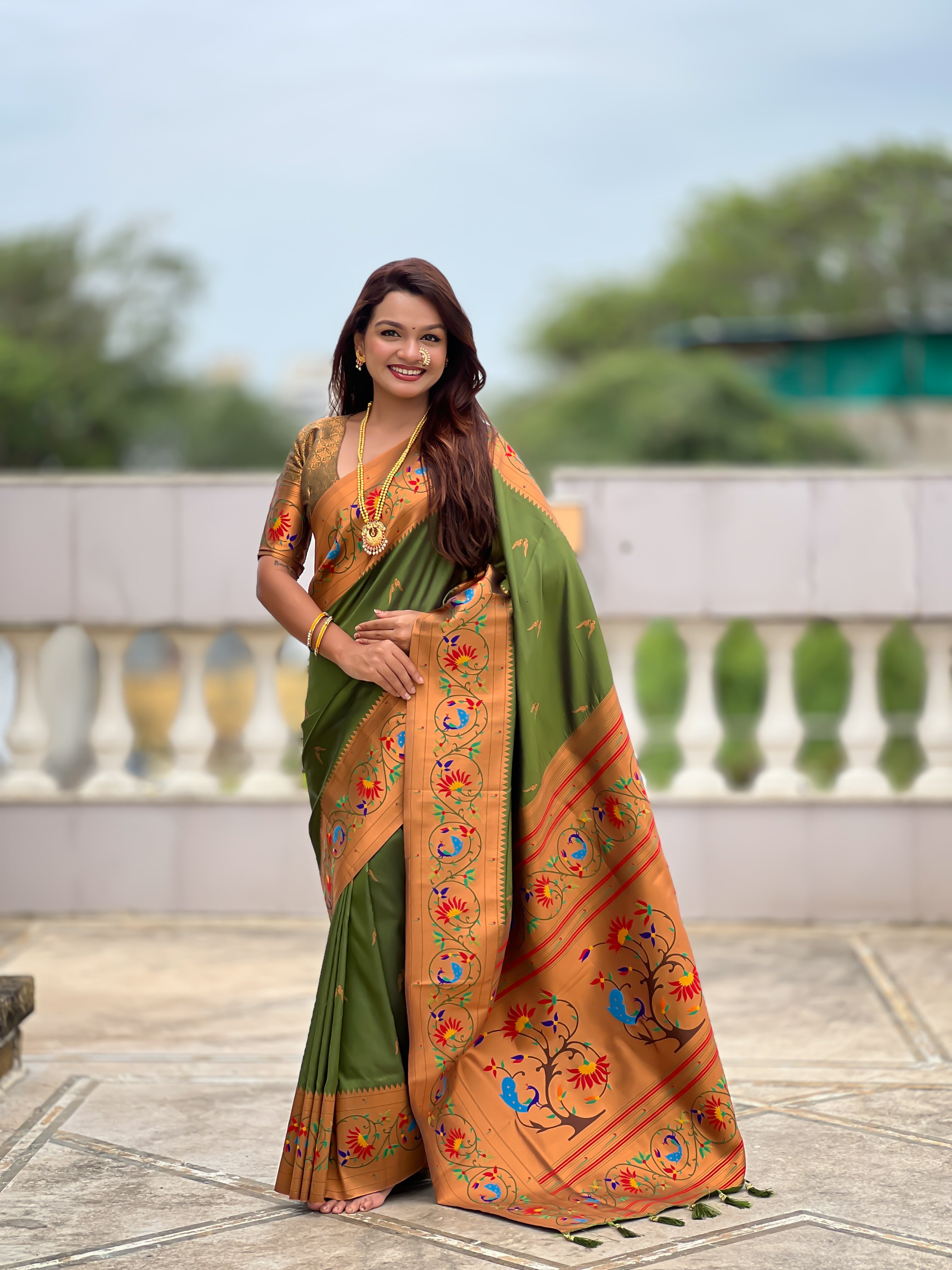 Model wearing Royal Soft Paithani Silk Saree with gold Zari weaving and colorful Meenakari peacock motifs