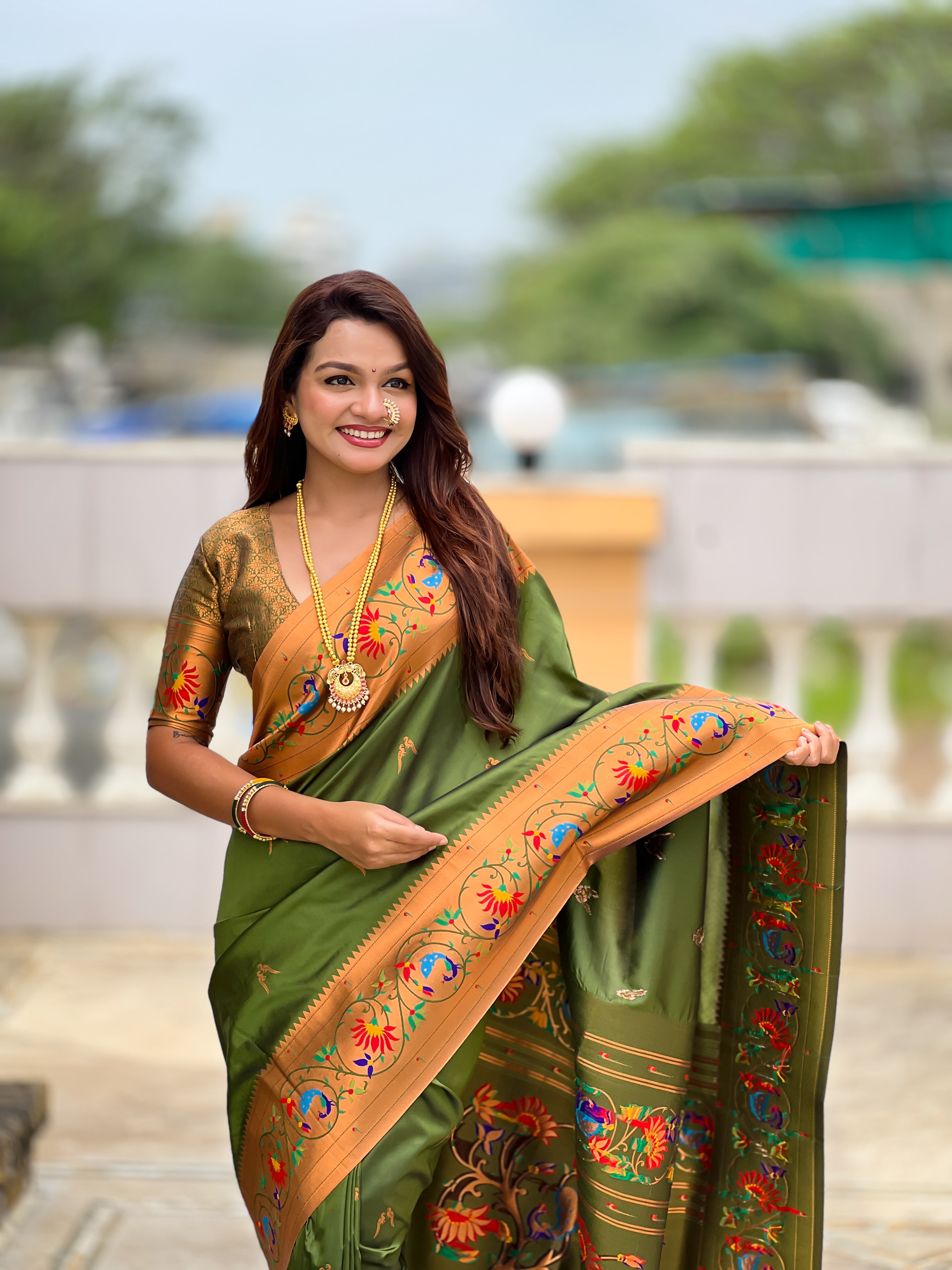 Model wearing Royal Soft Paithani Silk Saree with gold Zari weaving and colorful Meenakari peacock motifs