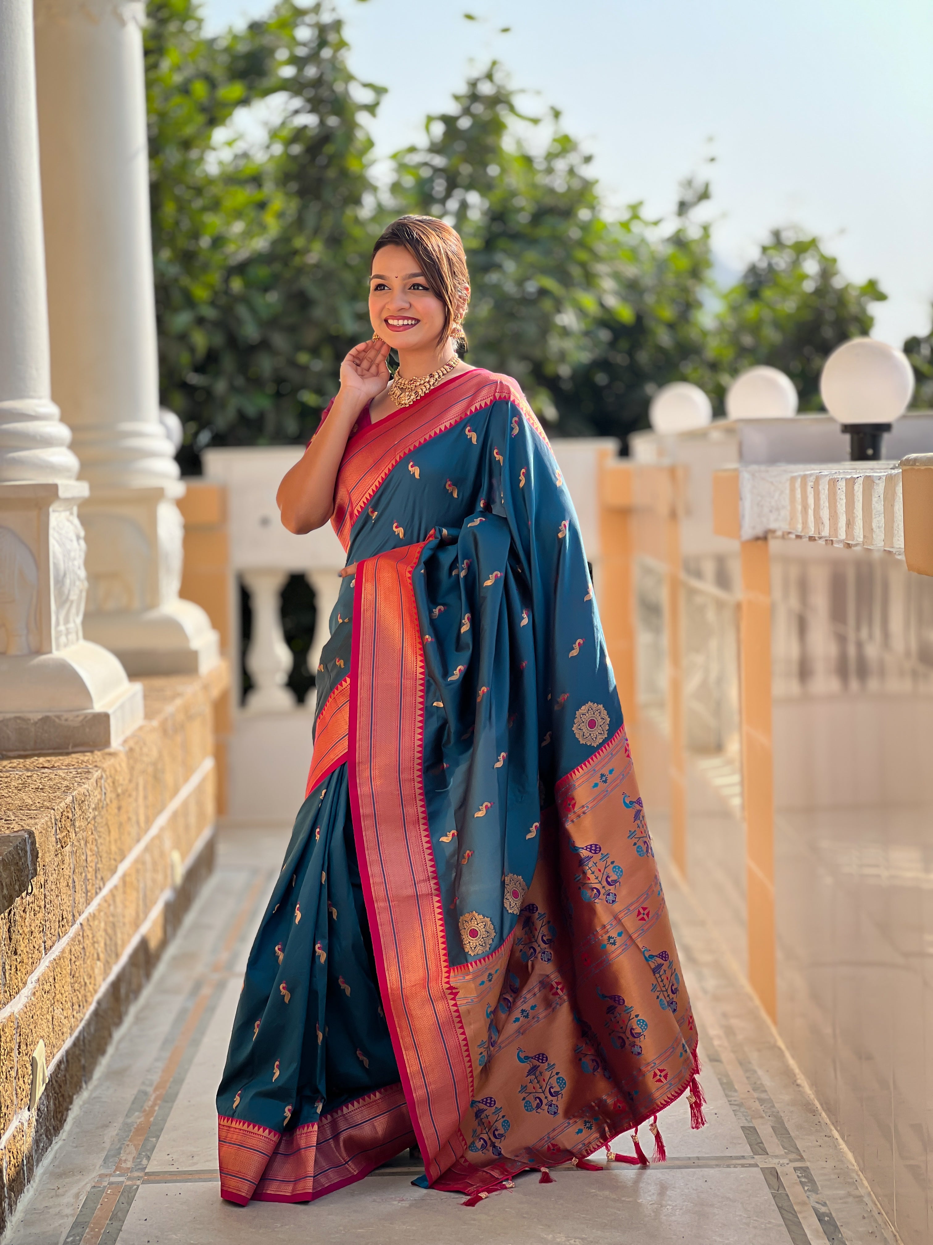 Woman wearing soft Paithani silk saree with meenakari zari border and rich pallu