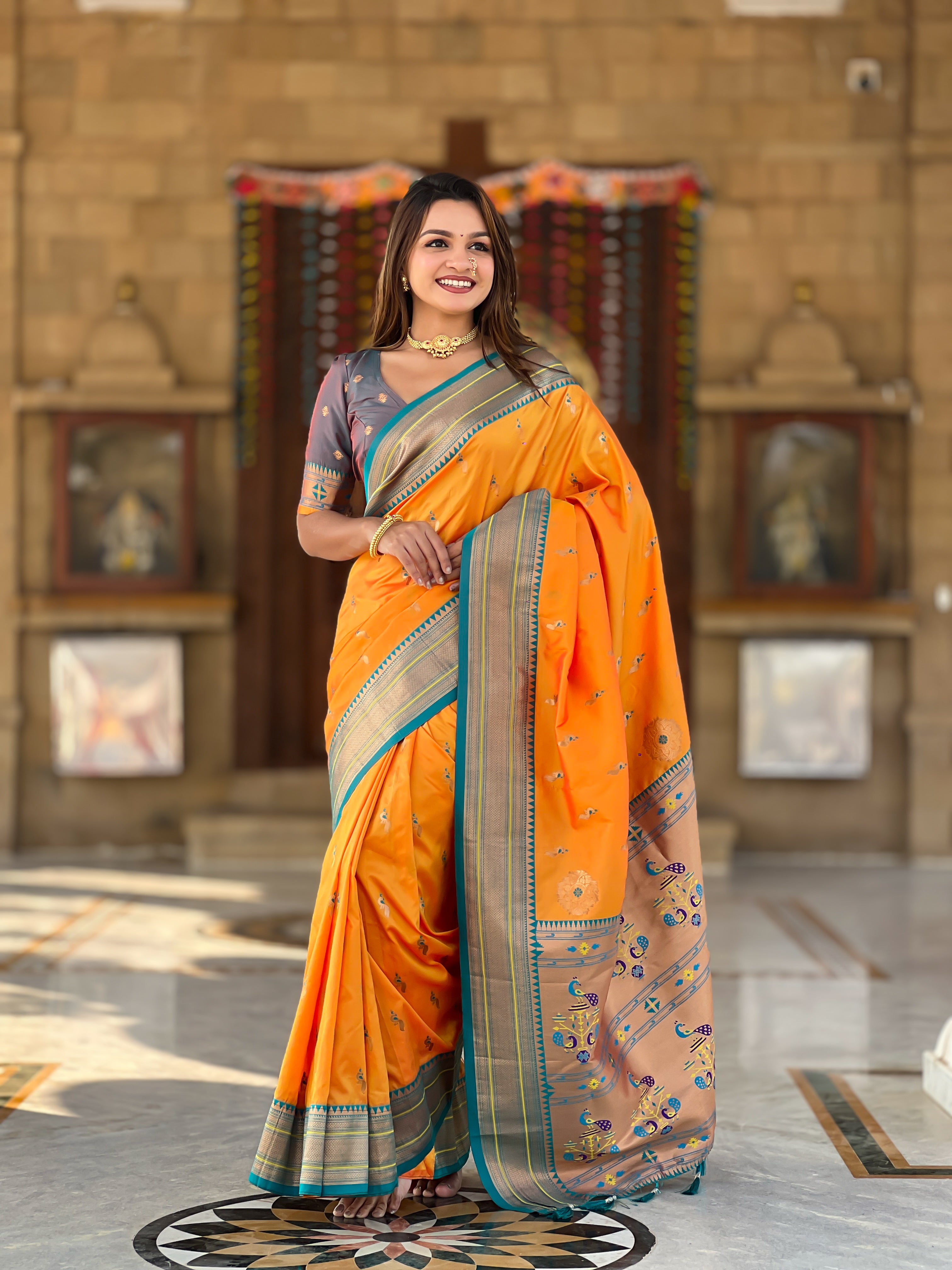 Woman wearing soft Paithani silk saree with meenakari zari border and rich pallu