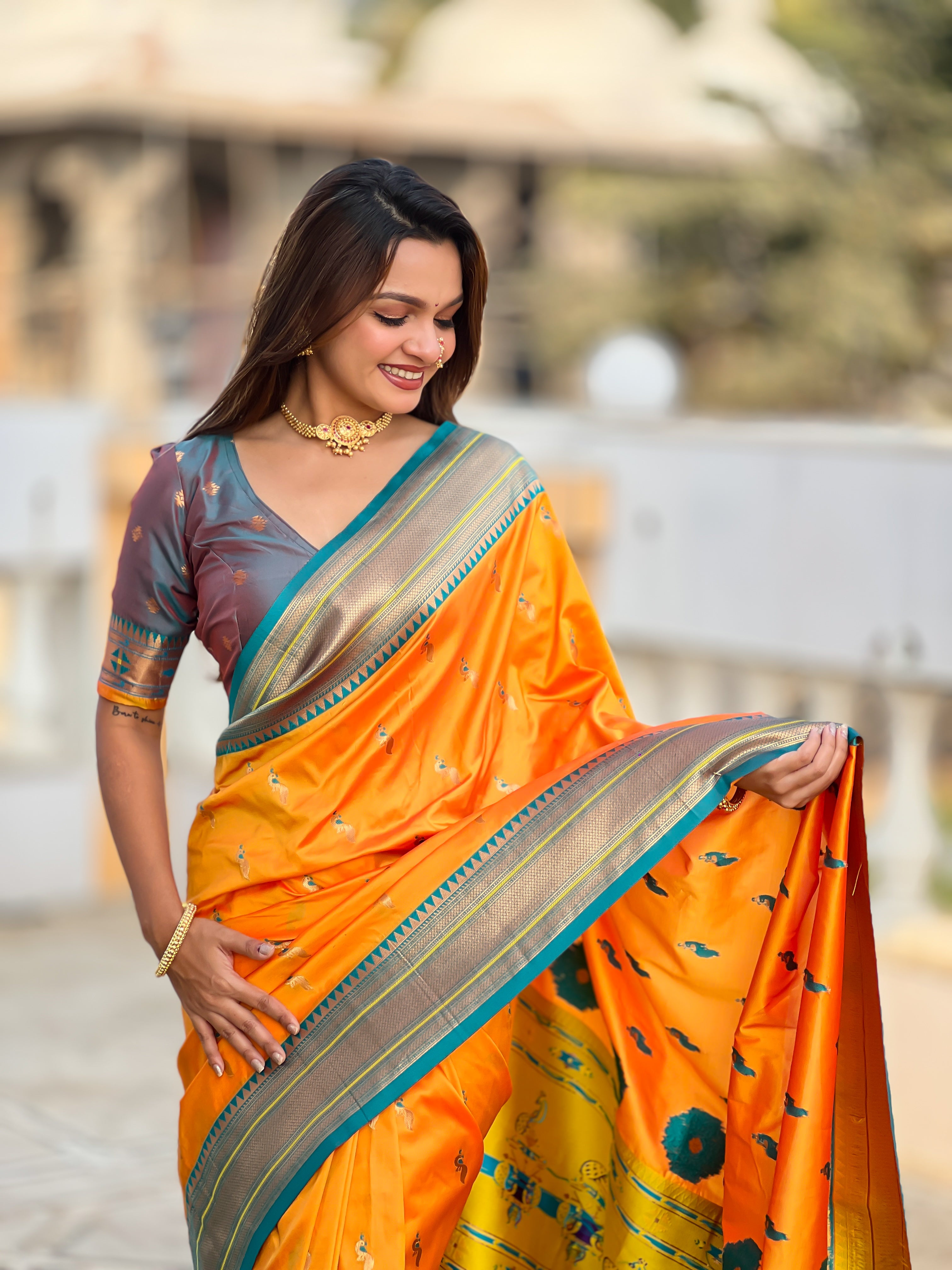 Woman wearing soft Paithani silk saree with meenakari zari border and rich pallu