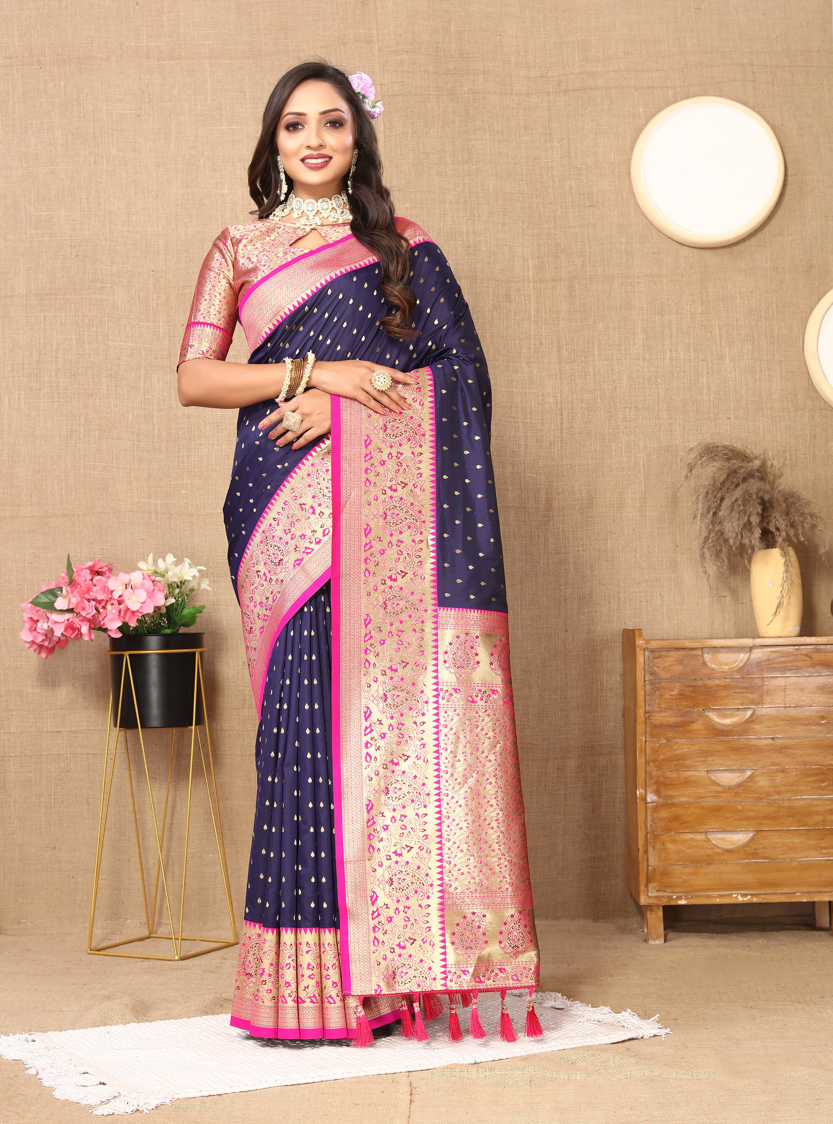Woman wearing N Blue soft silk saree with pink contrast border, gold zari motifs, and rich pallu design