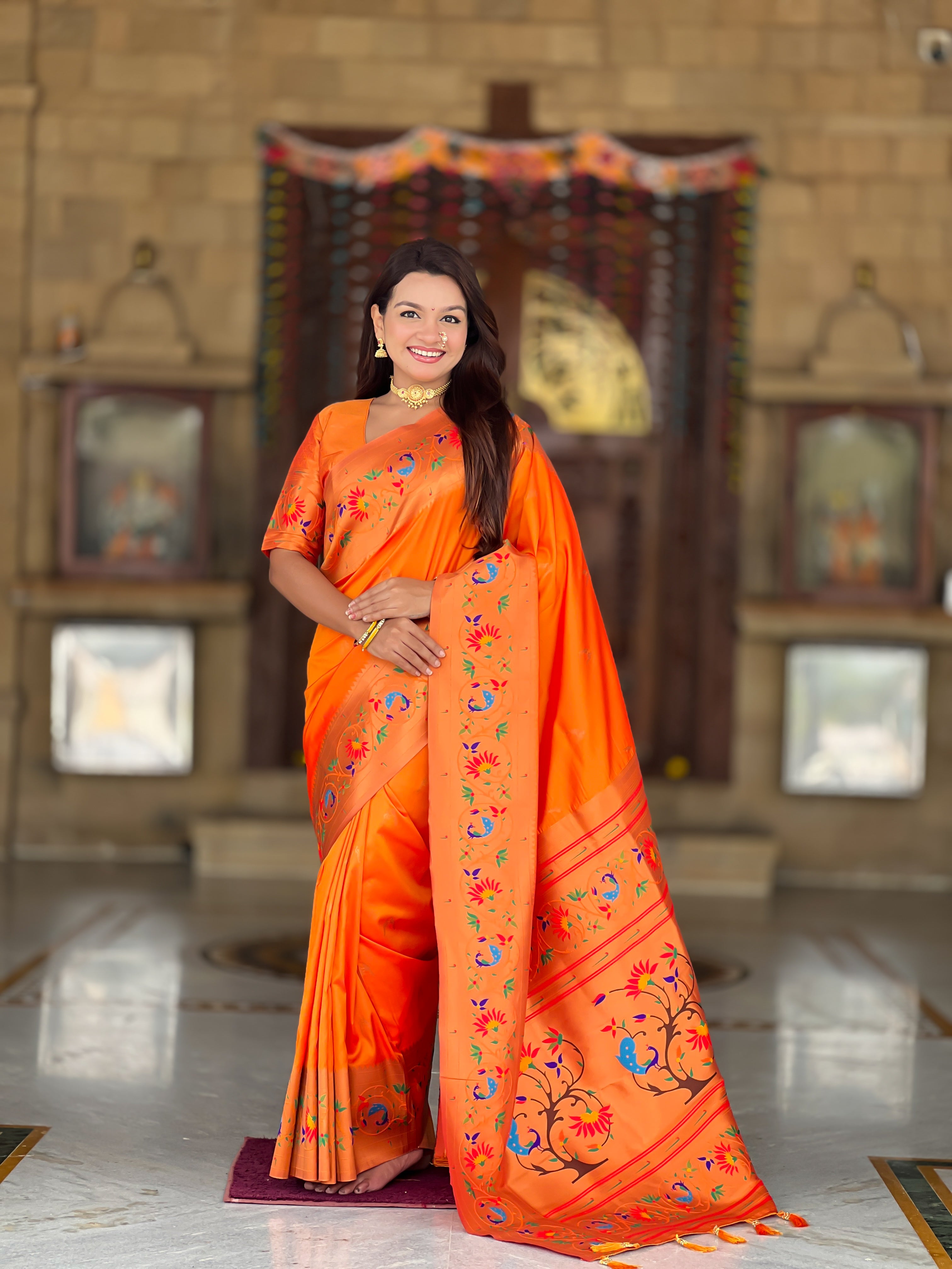 Model wearing Royal Soft Paithani Silk Saree with gold Zari weaving and colorful Meenakari peacock motifs