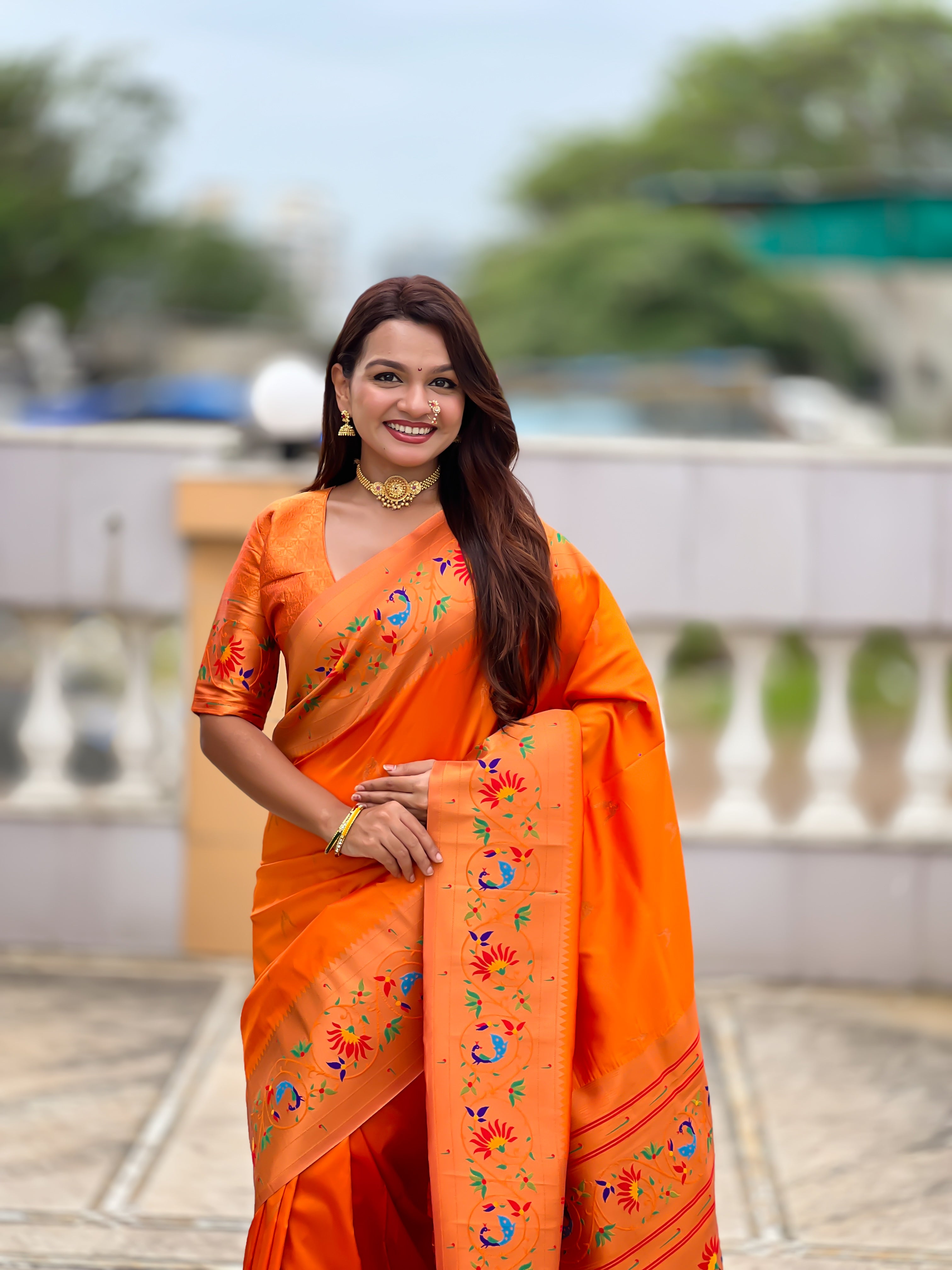 Model wearing Royal Soft Paithani Silk Saree with gold Zari weaving and colorful Meenakari peacock motifs