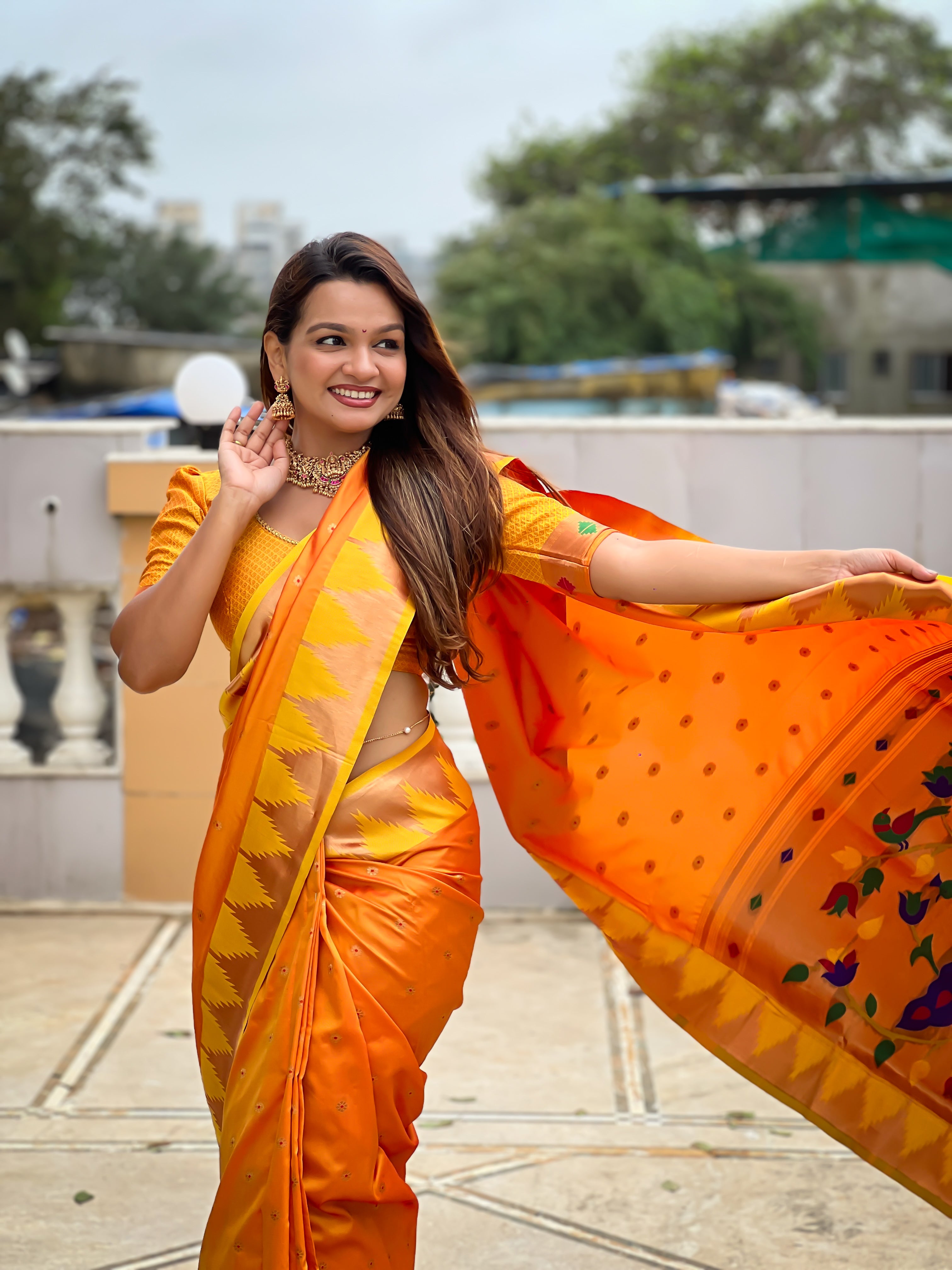Firozi blue soft Paithani silk saree with Meenakari pallu and temple border worn by a model in a traditional setting