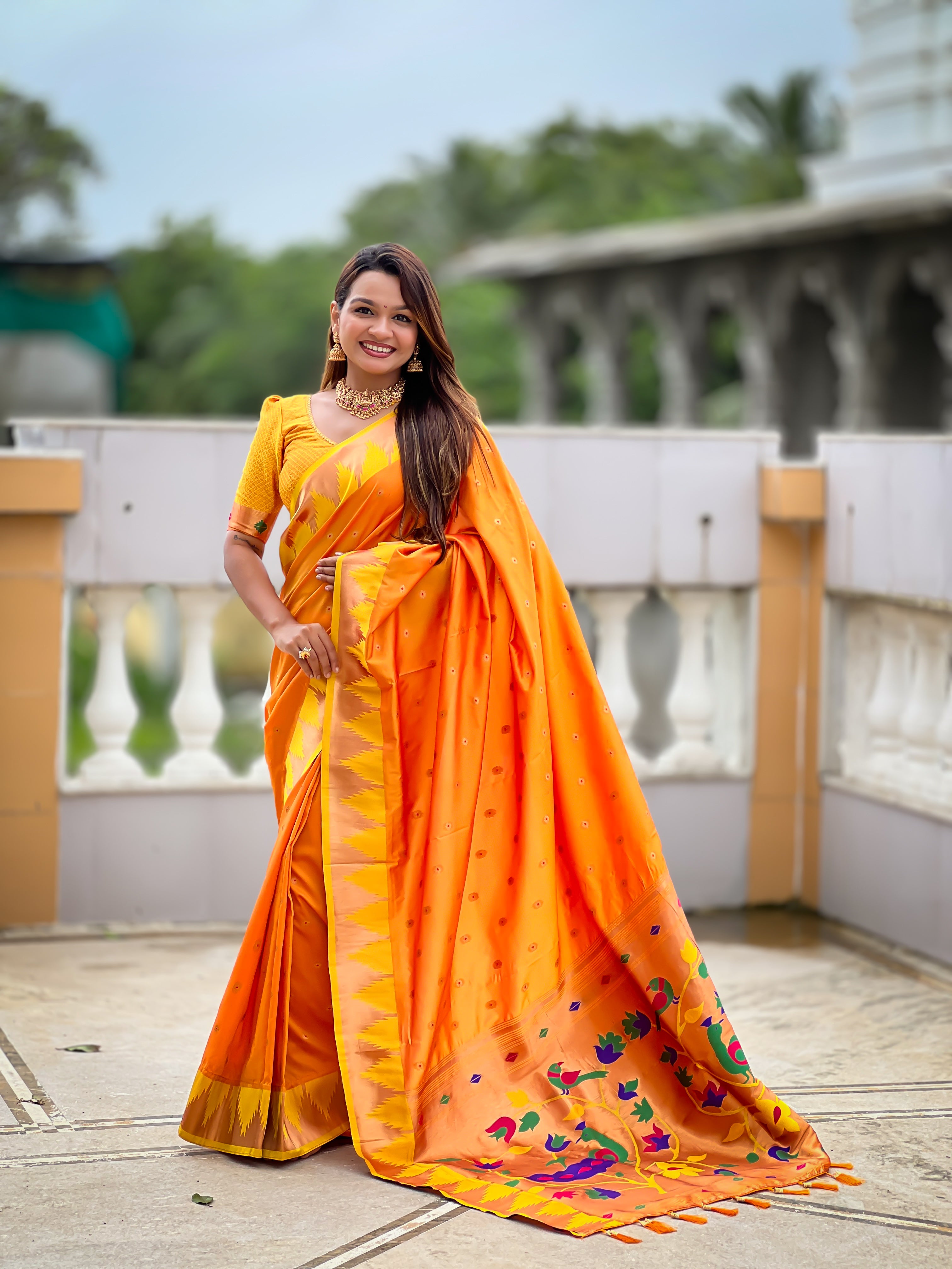 Firozi blue soft Paithani silk saree with Meenakari pallu and temple border worn by a model in a traditional setting