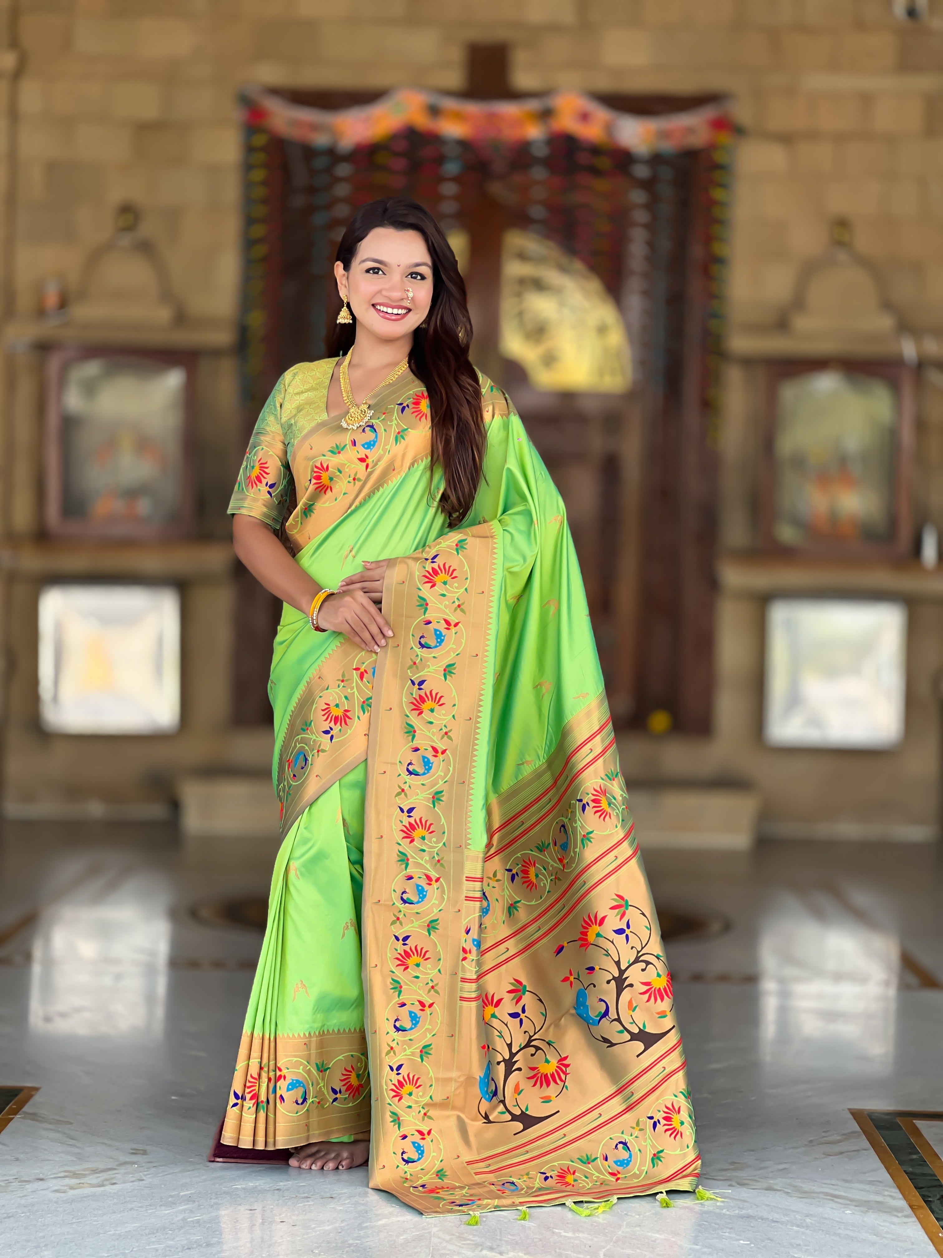 Model wearing Royal Soft Paithani Silk Saree with gold Zari weaving and colorful Meenakari peacock motifs