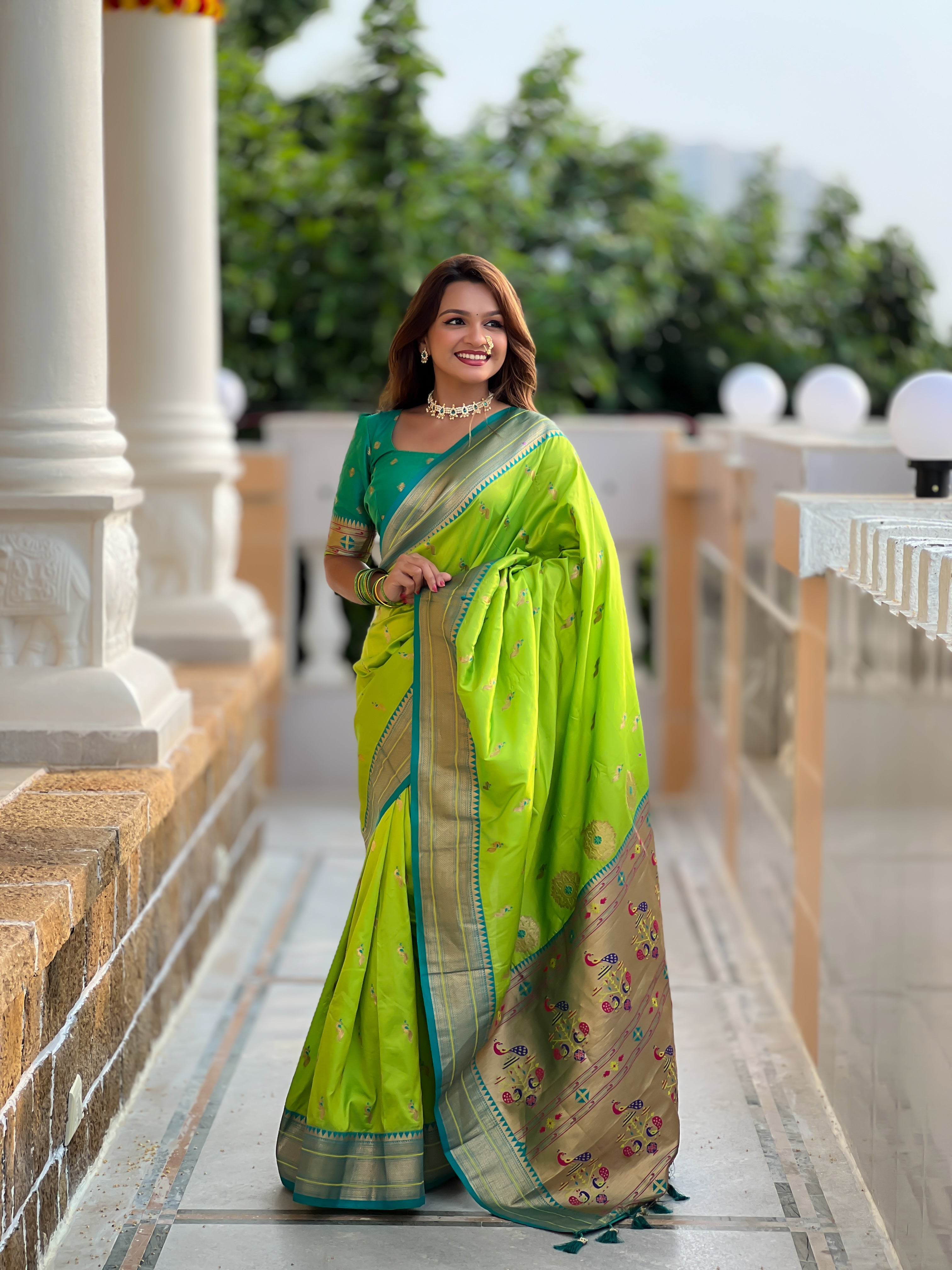 Woman wearing soft Paithani silk saree with meenakari zari border and rich pallu