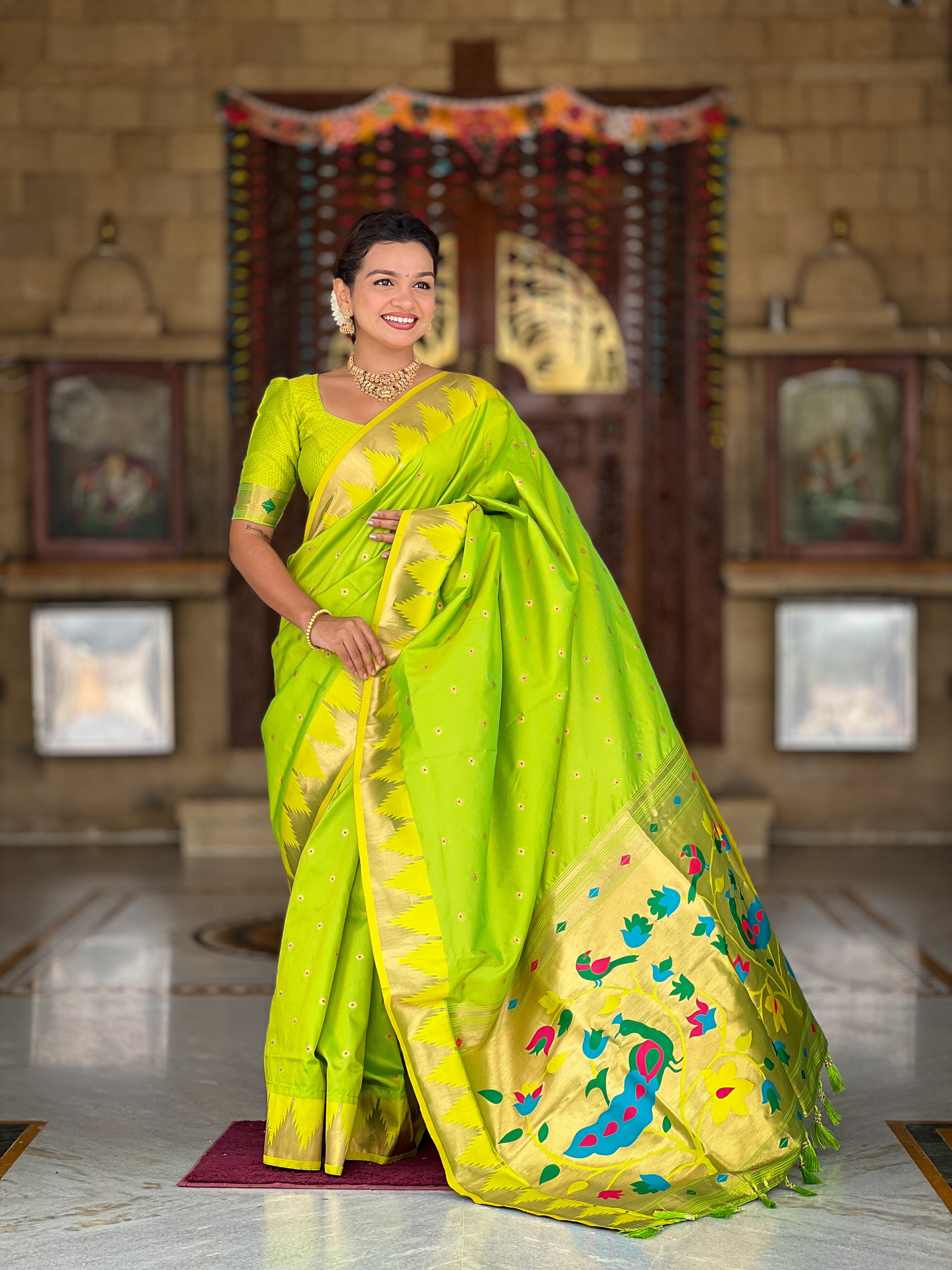 Firozi blue soft Paithani silk saree with Meenakari pallu and temple border worn by a model in a traditional setting