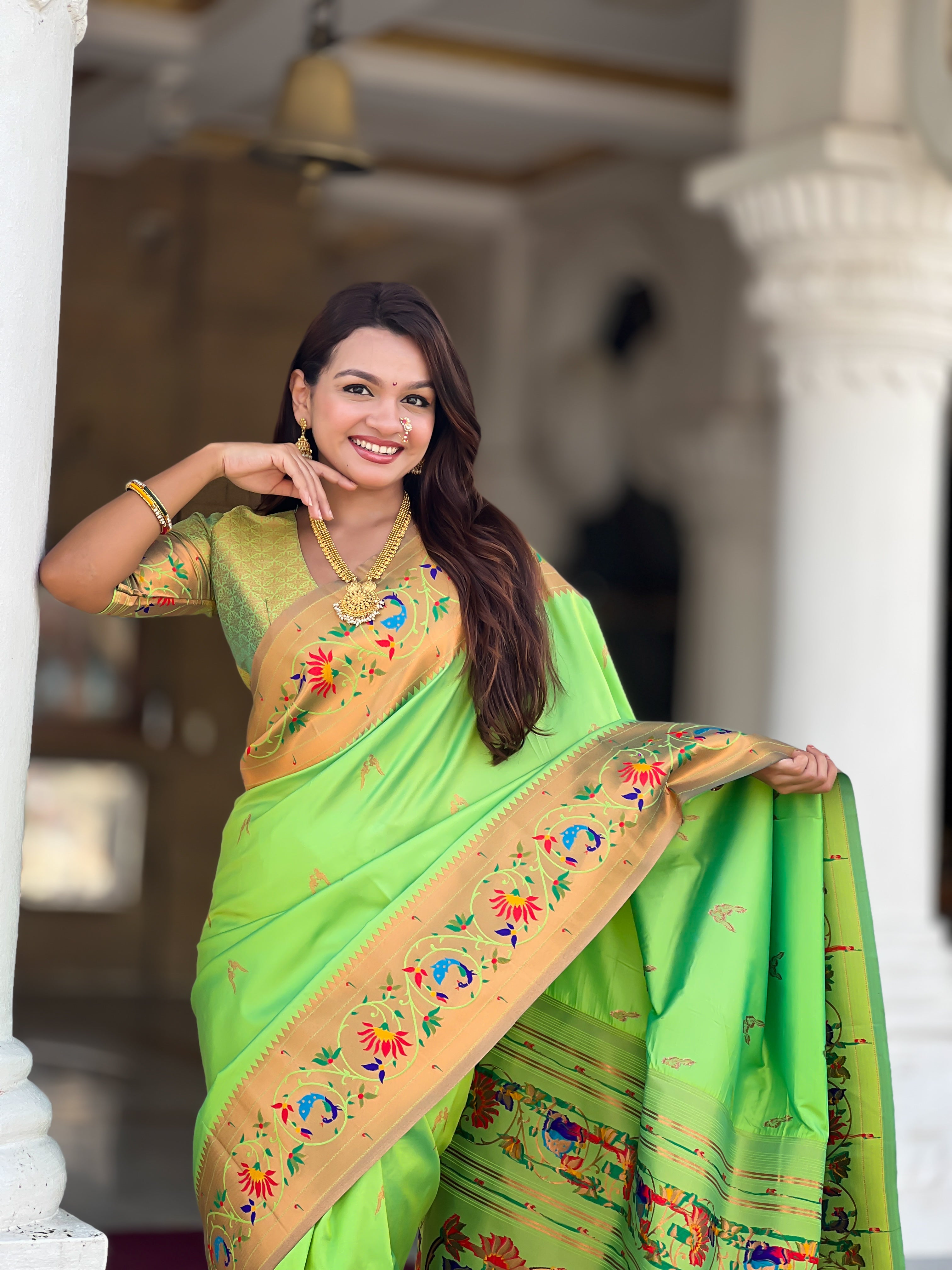 Model wearing Royal Soft Paithani Silk Saree with gold Zari weaving and colorful Meenakari peacock motifs