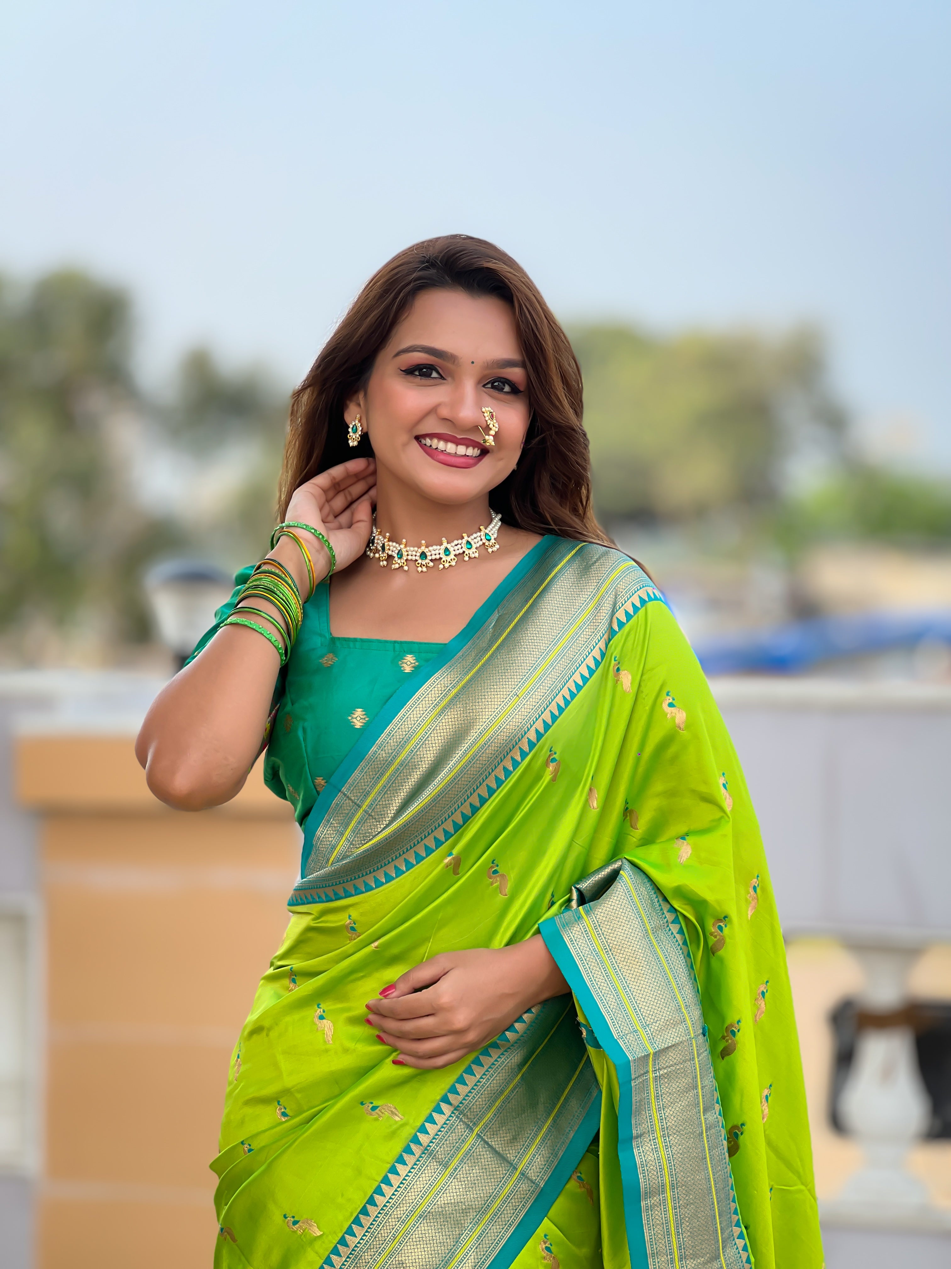Woman wearing soft Paithani silk saree with meenakari zari border and rich pallu