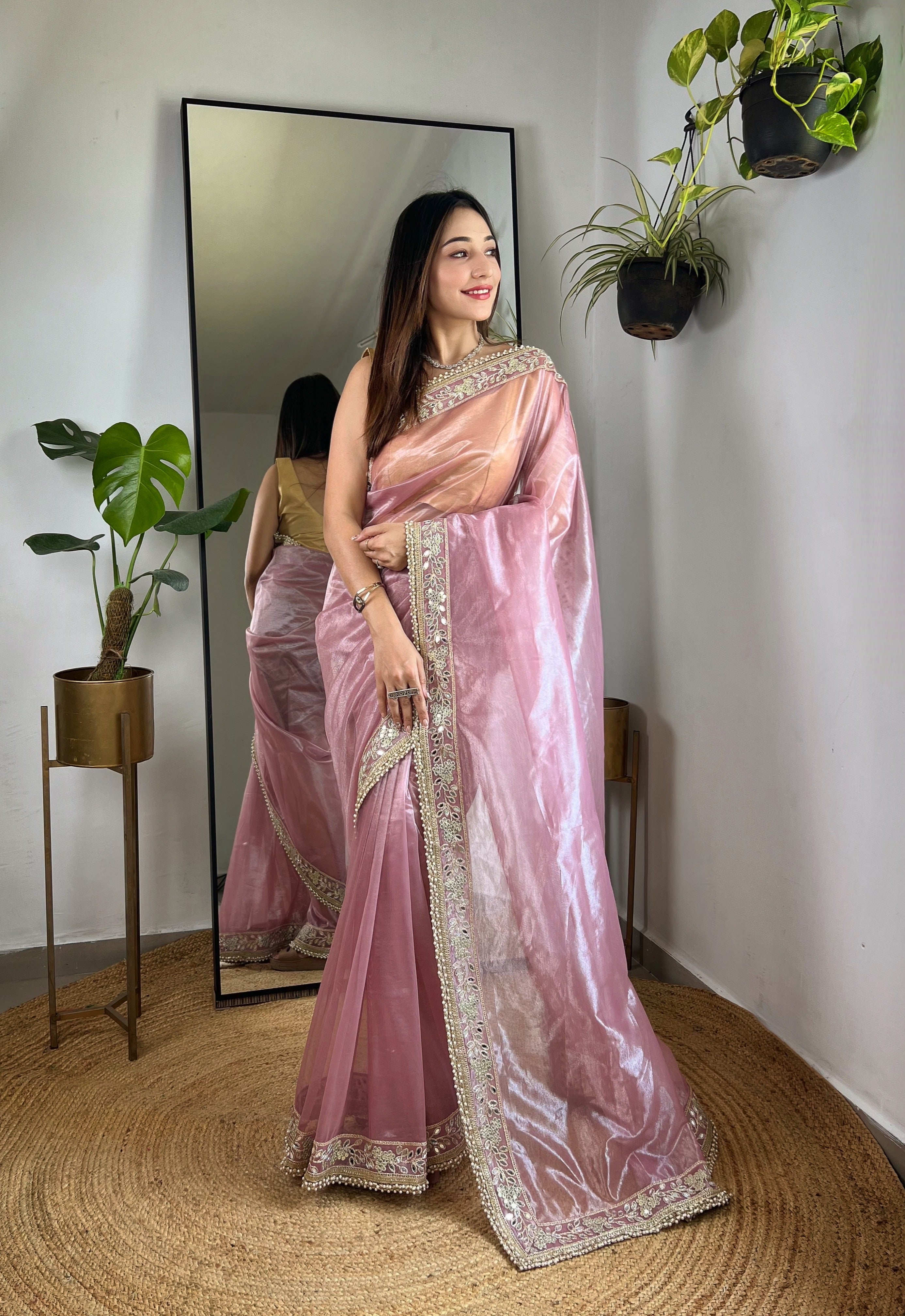 Silver tissue silk saree with real mirror work, zari dori embroidery and moti lace border worn by model