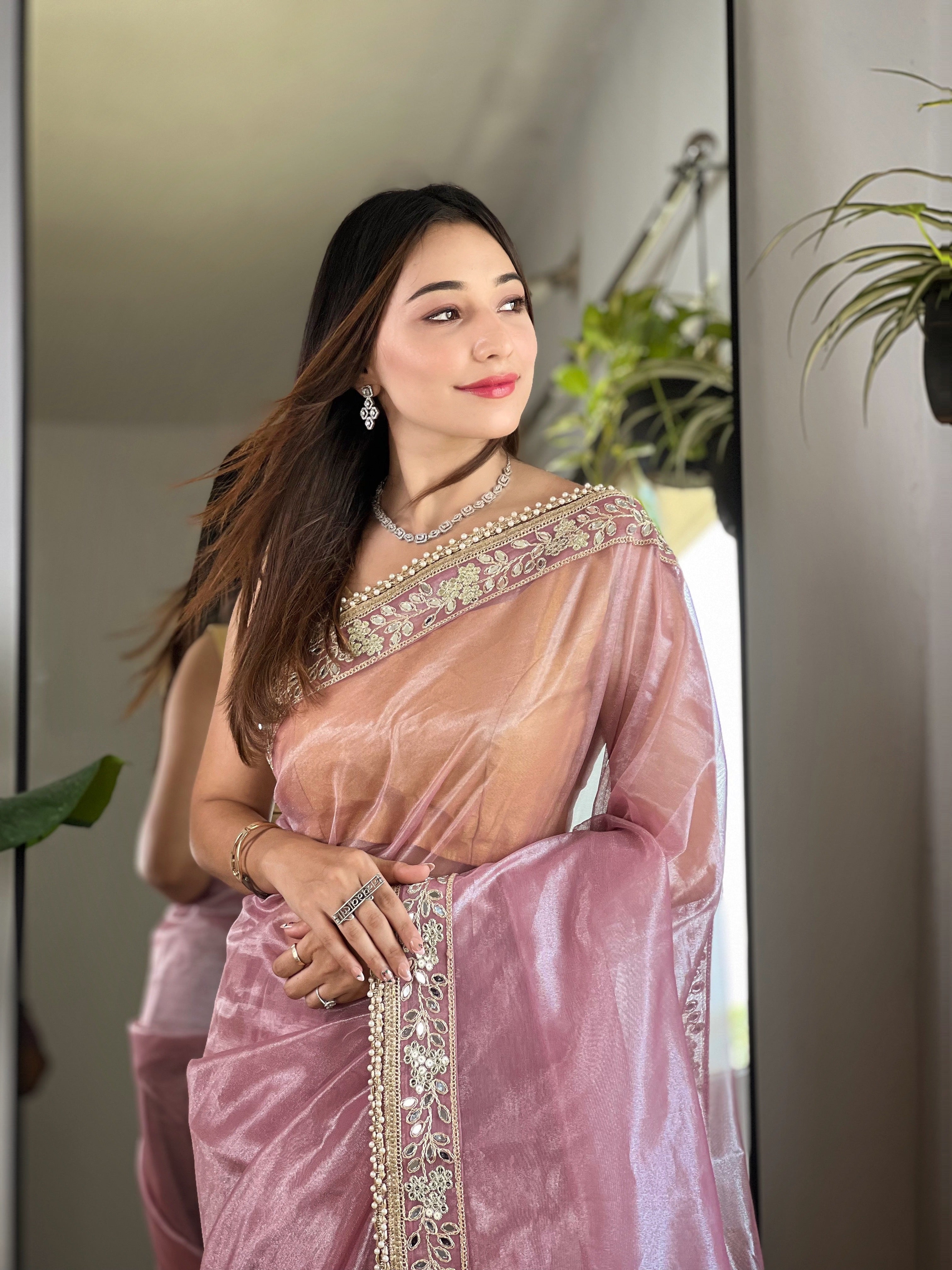 Silver tissue silk saree with real mirror work, zari dori embroidery and moti lace border worn by model