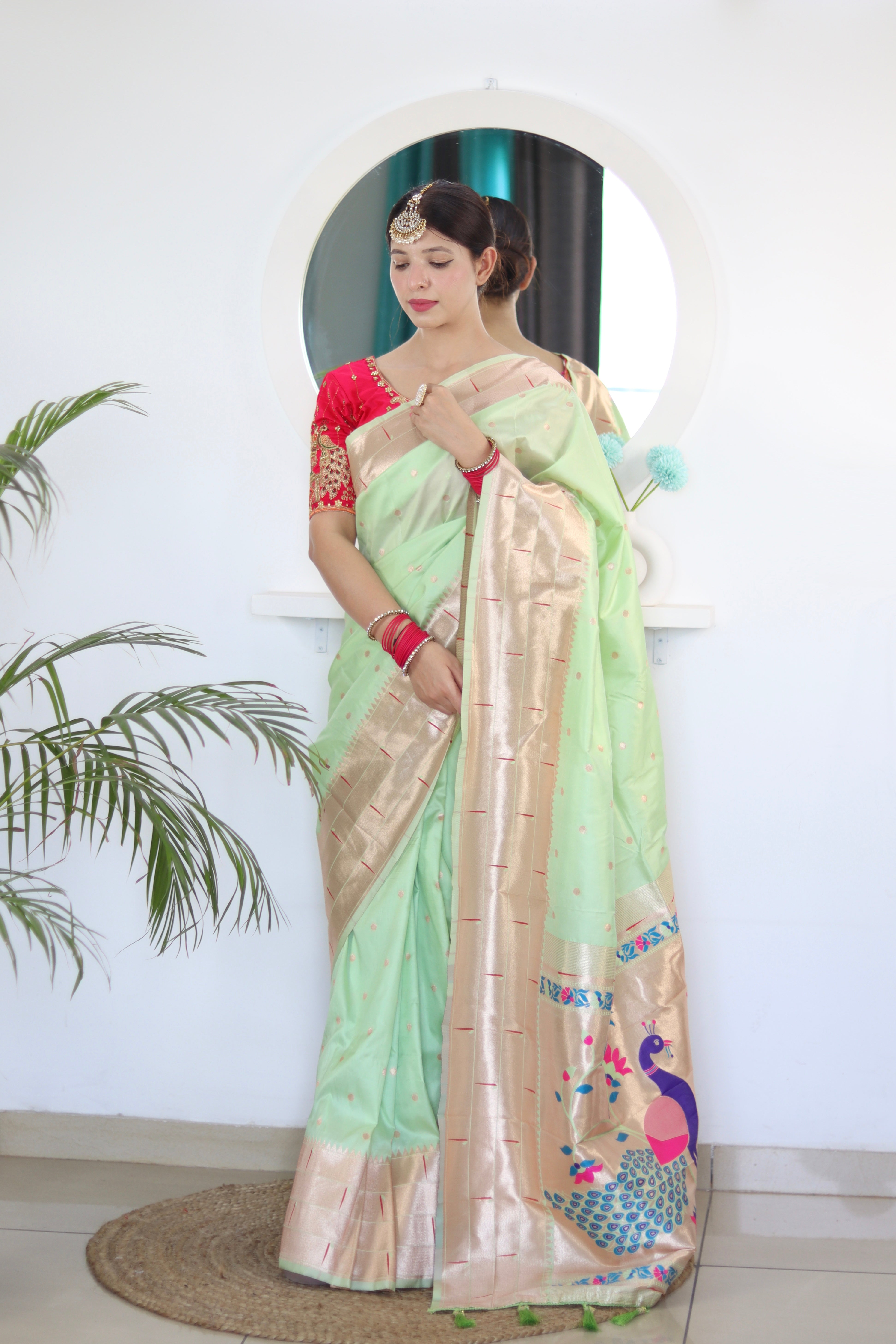 Model wearing Pista Soft Kanjivaram Paithani Silk Saree with Meenakari Zari weaving and rich swan border