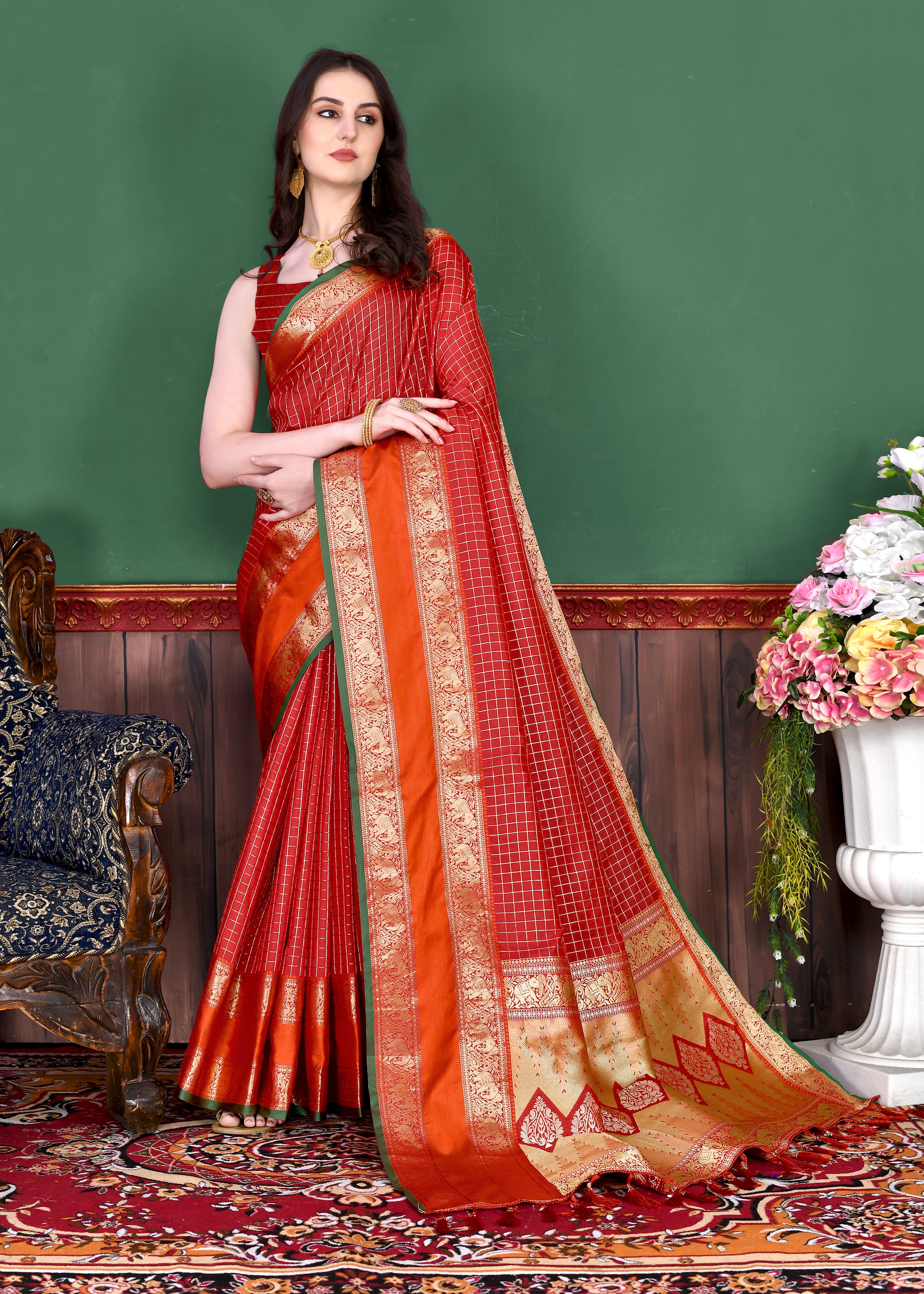 Woman wearing regal Red soft silk saree with gold zari checks, contrast border, and rich pallu with tassels