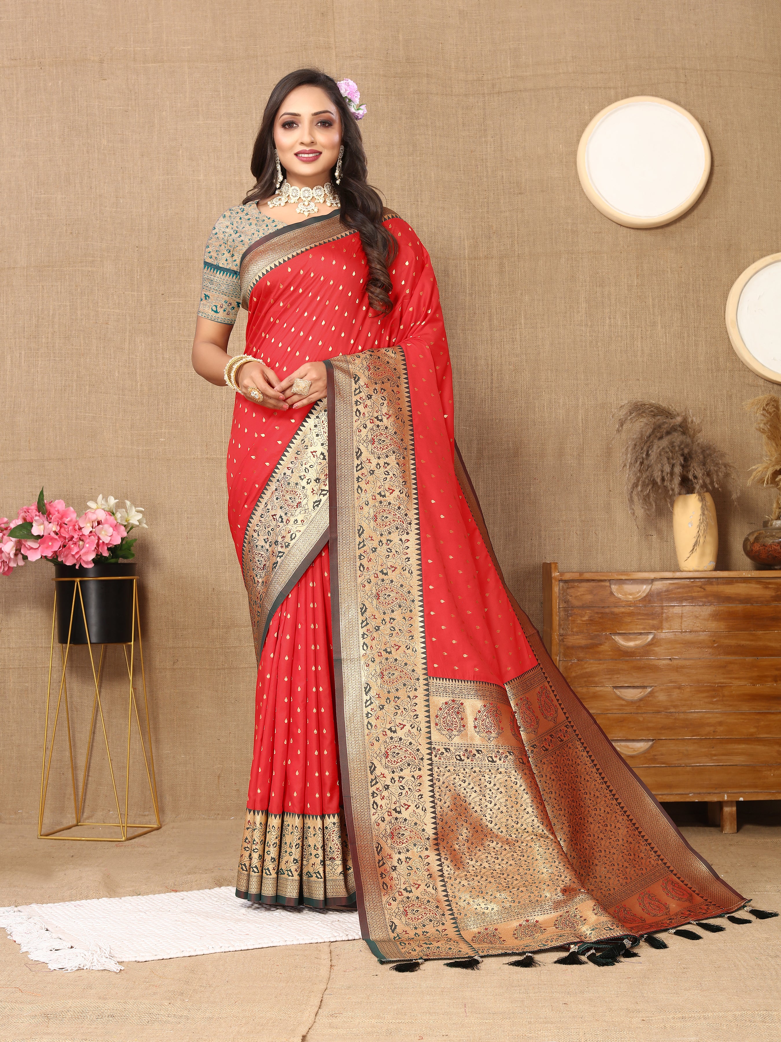 Woman wearing Red soft silk saree with pink contrast border, gold zari motifs, and rich pallu design