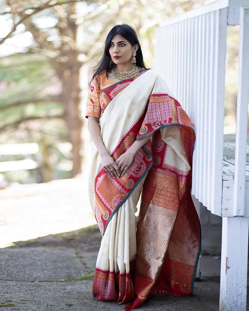 Woman wearing a traditional saree with a colorful pattern outdoors.