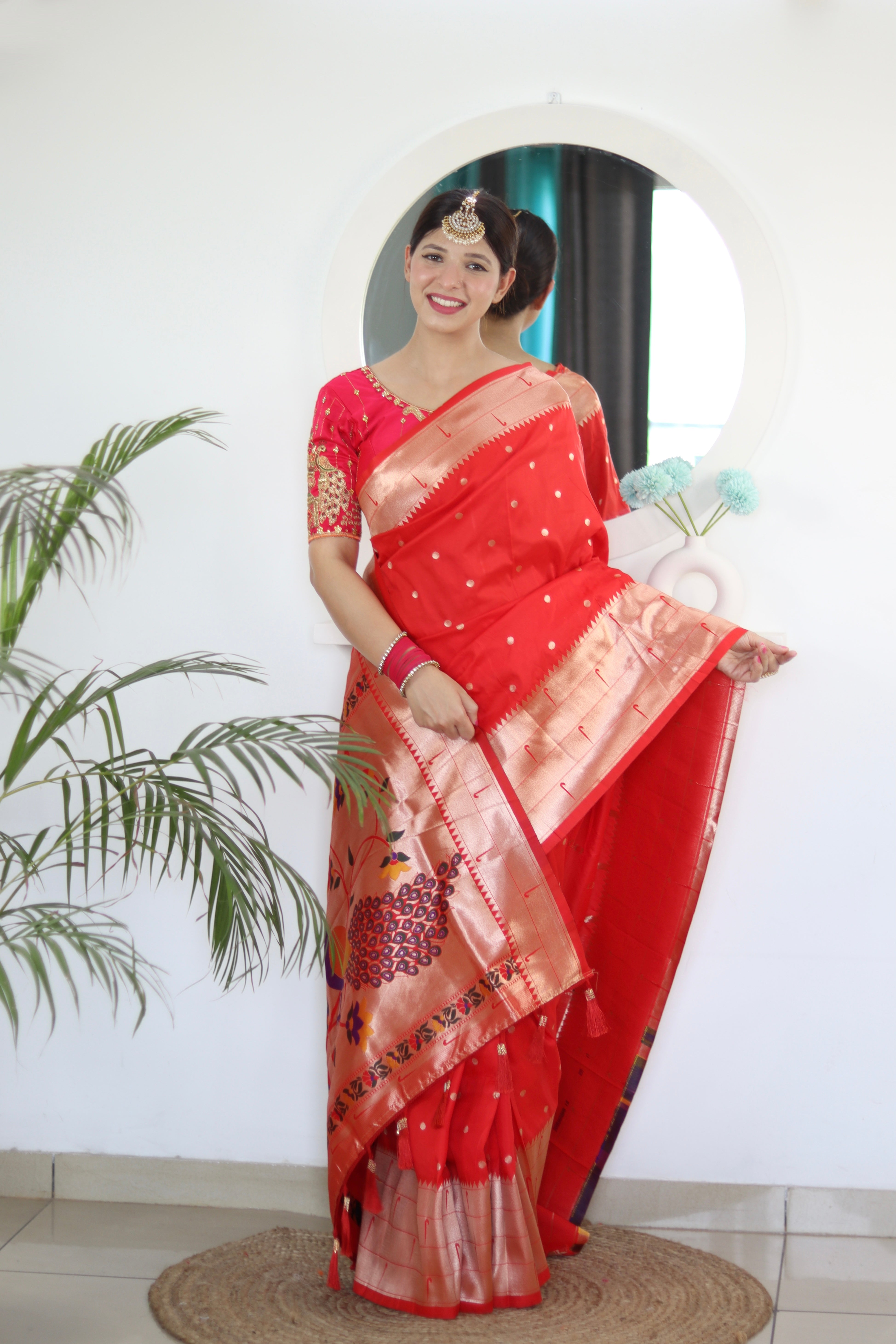 Model wearing Red Soft Kanjivaram Paithani Silk Saree with Meenakari Zari weaving and rich swan border