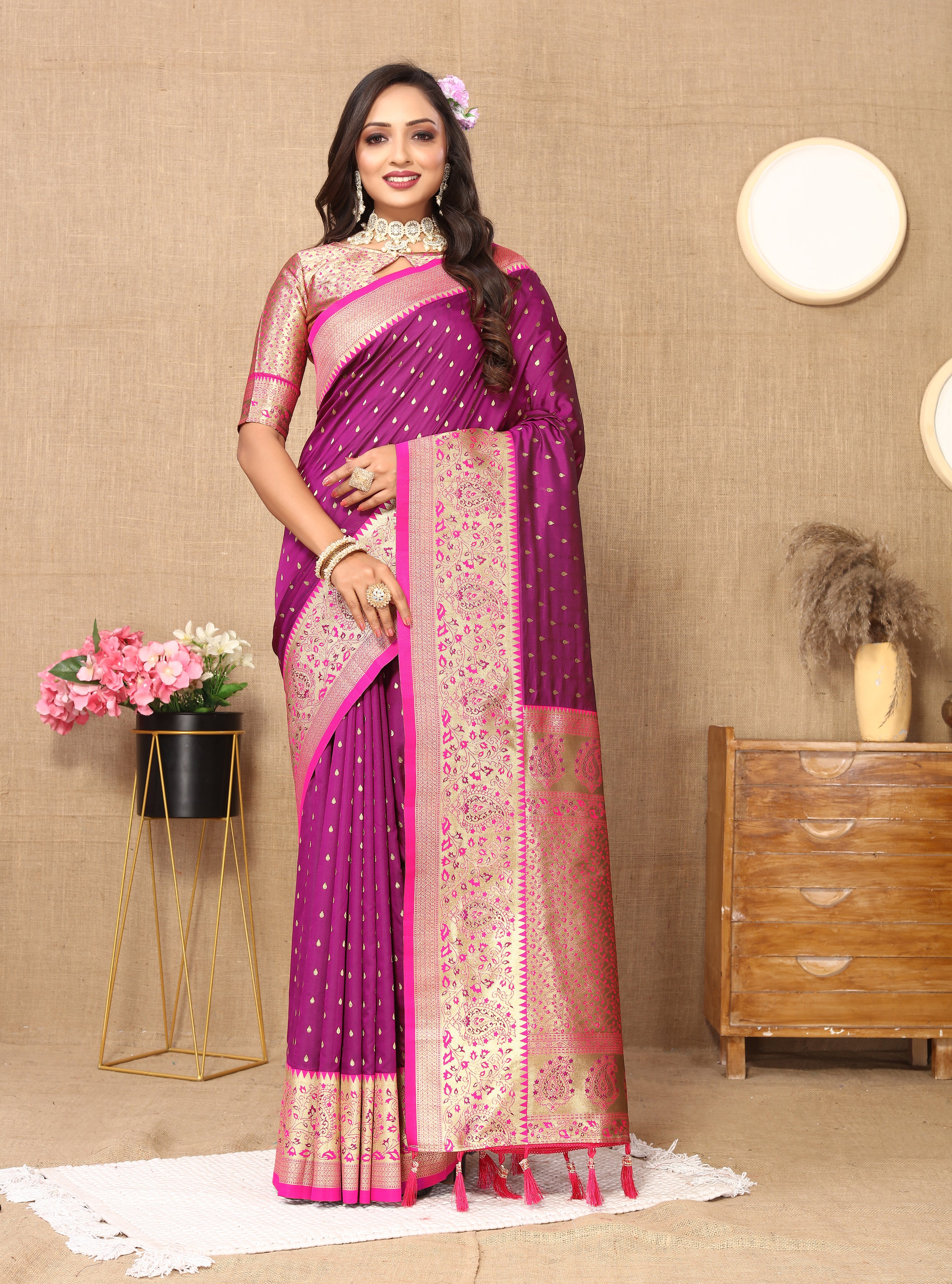 Woman wearing Wine soft silk saree with pink contrast border, gold zari motifs, and rich pallu design