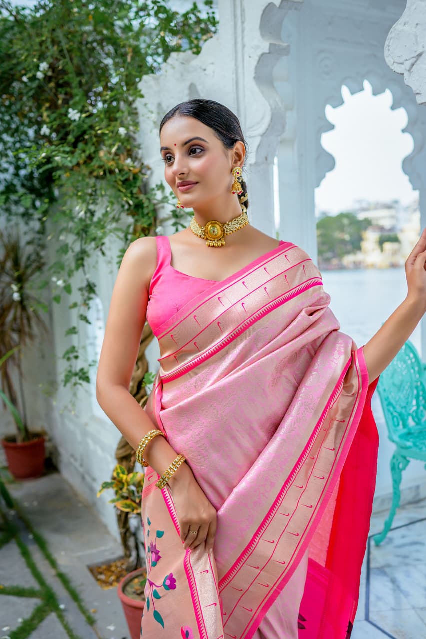 Model wearing grey Kanchi-Paithani fusion silk saree with blue border and colorful bird motif pallu standing in heritage courtyard