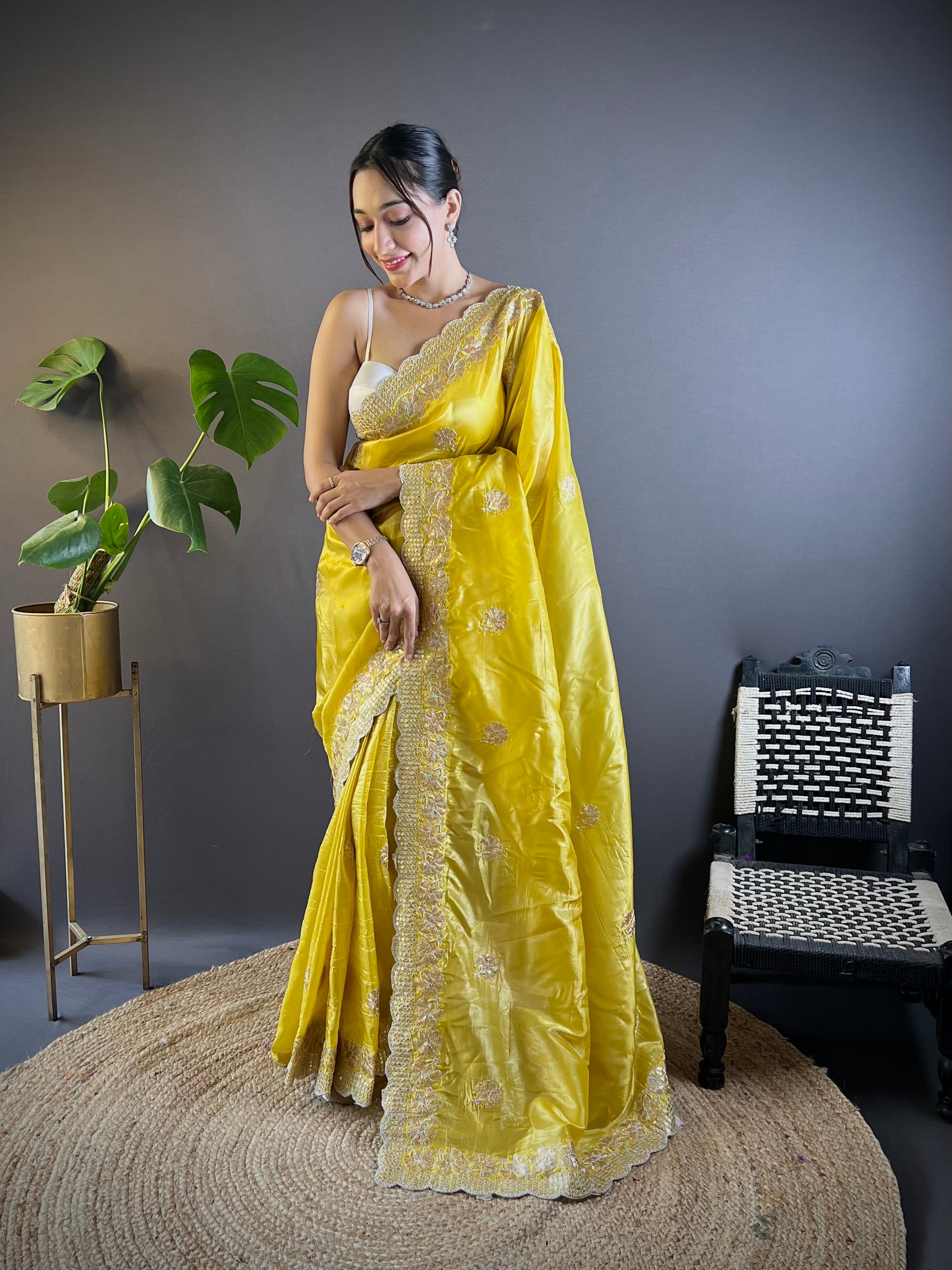Model wearing shimmering teal blue Gold Crunchy saree with floral sequence embroidery and cutwork border